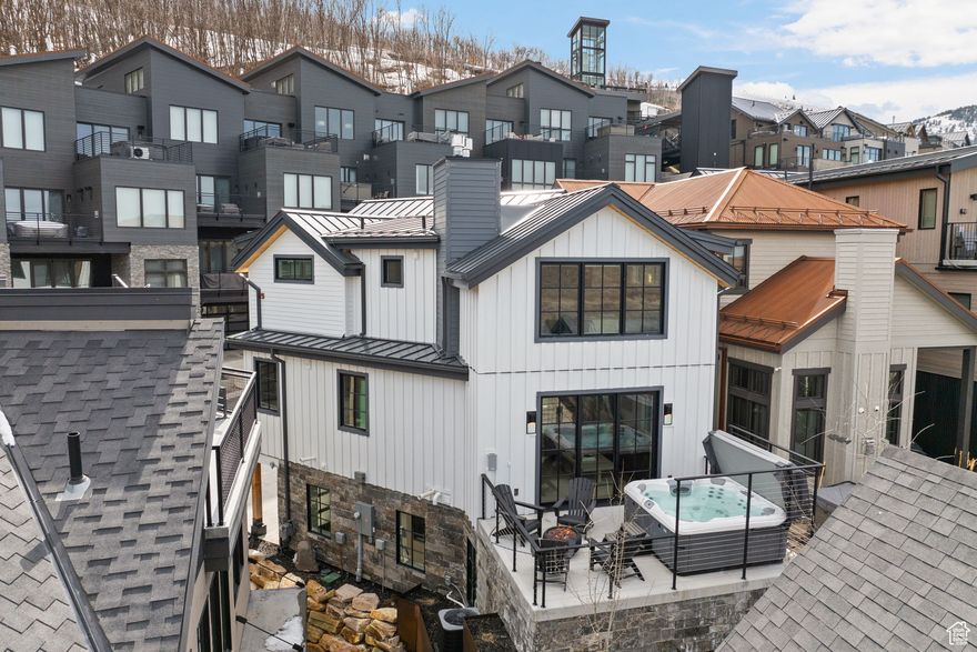 Experience unparalleled mountain living in this exquisite ski-in/ski-out residence, accessible via a private slope-side ski tower on the coveted Kings Crown Run. Masterfully designed, this home is the epitome of alpine elegance. The main level has an open-concept floor plan, where a spacious dining area flows into a welcoming family room centered around a cozy gas fireplace. White oak hardwood flooring and expansive windows fill the space with warmth and natural light. The kitchen features honed quartzite countertops, Sub-Zero fridge, Wolf range  and a large island. Sliding glass doors lead to a private deck complete with a hot tub and a comfortable sitting area-perfect for relaxing after a day on the slopes. The upper level has vaulted ceilings and a spacious primary bedroom complete with a gas fireplace and a convenient washer/dryer. The spa-like ensuite bathroom features a double-sink vanity with Vermont soapstone countertops, a large steam shower with a built-in bench, and a walk-in closet. A secondary guest suite also includes a beautifully appointed ensuite bath with custom tile work. The lower level includes a mudroom, two additional bedrooms (one with custom-built bunk beds), a three-quarter bath and  washer/dryer. The garage is equipped with a ski closet with boot heaters and ski grabbers. The home is designed for comfort, with heated floors throughout the lower level and all bathrooms. The heated driveway, front steps, and back patio ensure easy access year-round. Smart features include an alarm system, Ecobee thermostat and motorized shades. Directly across the street is the ski tower which is an exclusive amenity for Kings Crown owners and guests. It features an elevator and private ski lockers providing easy access to Kings Crown ski run. It also features a lounge, bar, hot tub, and a fire pit.  Located just a short walk from Historic Main Street for shopping and dining and minutes from hiking and biking trails