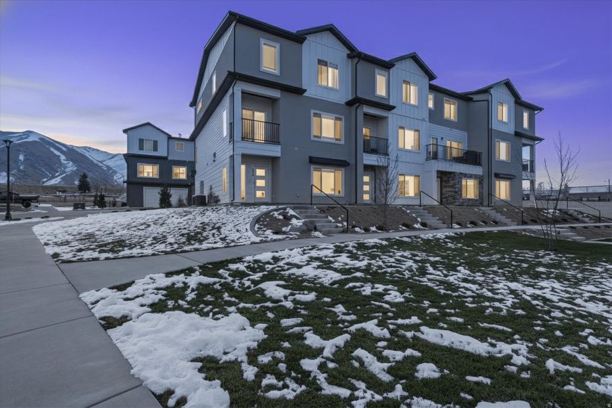 When modern comfort meets elevated design, you get this immaculate, move-in-ready townhome in Hyrum's Scenic Mountain Subdivision. Built in 2022, this 4-bedroom, 3-bath home offers 2,366 sq ft with 10' ceilings, an open-concept kitchen and living space, and generously sized bedrooms throughout. Step out and take in mountain views, unwind at the community playground, and enjoy high-speed Wi-Fi included in the HOA. Clean, spacious, and priced to stand out.  Schedule your showing before it's gone.
