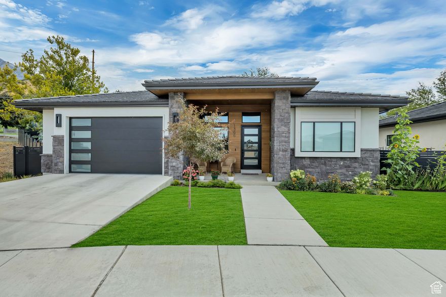 Price Improved by $50,000!  Discover refined living in this 2023 semi-custom home at the base of majestic Mt. Timpanogos. With 4 spacious bedrooms, 4.5 baths, and over 4,600 sq. ft., this modern prairie-style residence is a rare find in NE Orem's coveted Abbey Road Community. Step inside to an open main-level floor plan filled with natural light and elegant, high-end finishes. The gourmet kitchen boasts a full appliance package and walk-in pantry, while the main-level office makes working from home a pleasure. The luxurious primary suite features a spa-like bath with a soaking tub, separate shower, and an expansive walk-in closet. The fully finished basement offers a cozy family room and an impressive theater with projector and equipment, plus a kitchenette for effortless entertaining. Outside, your private backyard oasis is complete with mature landscaping, fruit trees, lush perennials, and a garden ready for summer harvests. This home also comes equipped with a Jellyfish exterior lighting system, custom programmable window shades, a whole-home security system with cameras, built-in sauna, and a sound system for the great room, primary suite, and back patio. Tech-savvy buyers will appreciate the Level 2 EV charger, making luxury living both comfortable and convenient. Set in a sought-after community known for its quality construction, modern design, and incredible views, this home offers the perfect balance of sophistication, comfort, and location.