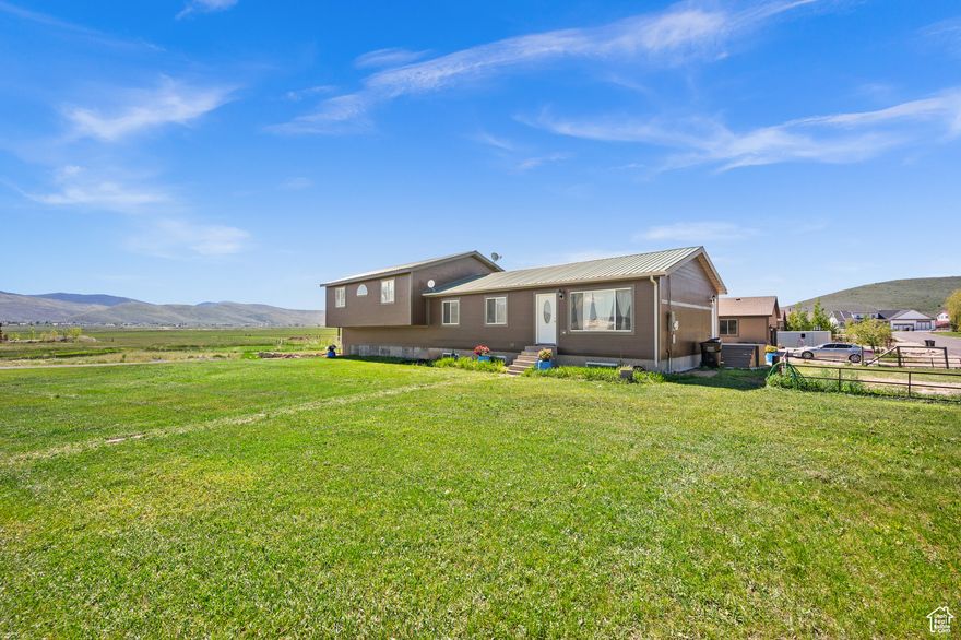 Large corner lot with expansive views of the Kamas valley. The 6 bedrooms 4 bath home has an oversized garage with extra storage, two family rooms, and the potential for a mother-in-law apartment in the lower level.  The welcoming country kitchen will bring the family together after a long day, then unwind in the back patio in the extra-large hot tub. The other bedrooms and features are ready for you to personalize.  The larger owner suite covers the width of the house with a large walk-in closet and even larger bathroom. Come see it for yourself.