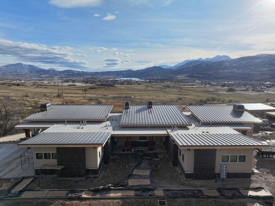 Nestled in a vacation paradise with year-round adventures, this exquisite home in the highly desired Ridge Townhomes is currently under construction and will be ready to move in by 2026. Zoned for nightly rentals, this property offers a seamless transition for those looking to invest in a vacation home. Set against the stunning backdrop of the Ogden Valley, this 3-bedroom, 3.5-bathroom luxury townhome boasts unparalleled views of Snowbasin, Pineview Reservoir, and the majestic Wasatch Mountains. This vaulted ceiling unit is beautifully appointed with upscale finishes, including an elevated deck, a stone fireplace, radiant-heated flooring on the lower level, a ground-level porch with a private hot tub, quartz countertops, and more. Beneath the garage lies a spacious bonus room ideal for a theater, game room, or additional living space. The oversized one-car garage accommodates large vehicles while providing ample storage. The open space behind the townhome ensures the breathtaking views remain unobstructed. Residents enjoy exclusive access to the HOA infinity pool and large group hot tub, perfect for relaxing year-round. Situated within the Wolf Creek Resort, this townhome is within walking distance of a Powder Mountain pick-up and drop-off location, offering unmatched convenience alongside hiking, biking, skiing, golfing, and endless outdoor activities, and only an hour from Salt Lake City International Airport. High-speed internet is available. Square footage figures are provided as a courtesy estimate only and were obtained from County Records. Buyer is advised to obtain an independent measurement.