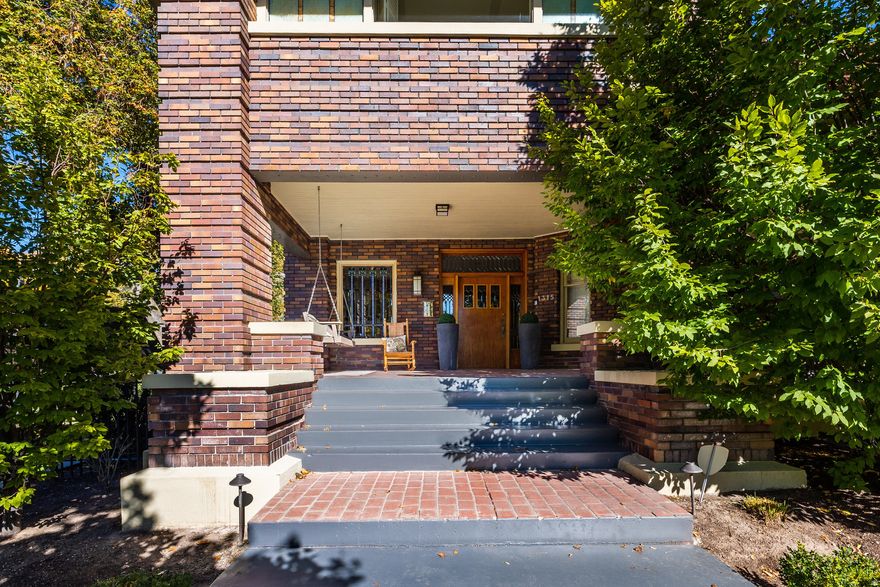 Introducing theTracy Estate, a landmark residence that gracefully bridges Salt Lake City's historic past and its sophisticated present. Nestled between the foothills and downtown inprestigious Federal Heights, this stately brick two-story occupies adouble lotsurrounded by mature trees, privacy, and enduring architectural beauty. Originally designed and built forRussell Tracy of the famed Tracy Aviary, the home showcasesstained-glass windows, intricate moldings, and exquisite craftsmanshiprarely replicated today. Thoughtfully updated for modern living, it retains every ounce of its original charm, blending classic formality with comfortable, open spaces ideal for contemporary lifestyles. The main level flows seamlessly between formal and casual living areas, each framed bysoaring ceilings and luminous windows. Upstairs, all bedrooms enjoyprivate ensuite baths, while theprimary suiteoffers two fireplaces, a private terrace, a spa-like bath, and an impressive walk-in dressing room. A flexible third-story retreat currently serves as an art studio and playroom, easily adaptable to afifth bedroom suite or private office, complete with its own bath. The lower-level invites gathering and relaxation with awet bar, wine cellar, and media spaces. The outdoor living experience rivals the interior with awraparound deck, manicured double yard, and effortless access from nearly every main-level room. Whether entertaining or unwinding, the estate's connection to nature and light is ever present. Located minutes from downtown dining, the University of Utah, and trailheads to City Creek and the foothills, this isa home that embodies both heritage and lifestyle. Timeless, rare, and quintessentially Federal Heights.