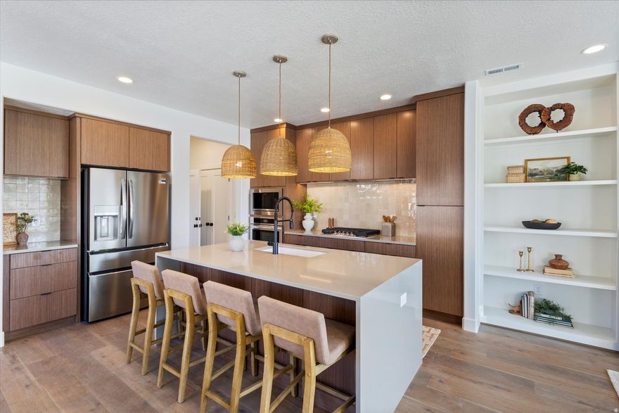 Step into the Wildwood floorplan living at its finest! This gorgeous corner-lot home features a chef-inspired kitchen with a Buit-in range, hood, and wall oven!, With lofty 9-ft ceilings on all levels the primary suite stuns with a vaulted ceiling and your own private balcony-perfect for morning coffee or sunset unwinding! With warm wood cabinetry, sleek quartz counters, and access to open land and miles of trails, this home blends luxury with nature in all the best ways. This is the LAST Wildwood until late summer! Completion April 2026