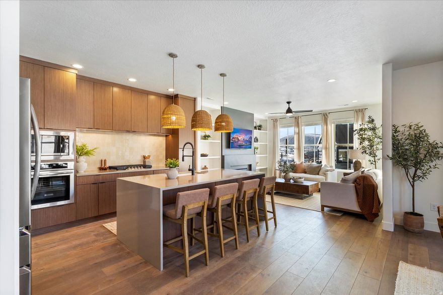 Step into the Wildwood floorplan living at its finest! This gorgeous corner-lot home features a chef-inspired kitchen with a Buit-in range, hood, and wall oven!, With lofty 9-ft ceilings on all levels the primary suite stuns with a vaulted ceiling and your own private balcony-perfect for morning coffee or sunset unwinding! With warm wood cabinetry, sleek quartz counters, and access to open land and miles of trails, this home blends luxury with nature in all the best ways. This is the LAST Wildwood until late summer! Completion April 2026