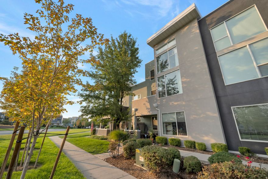 Bright and spacious Daybreak condo with soaring two-story windows and an open, airy layout. The kitchen features a large island, and plenty of counter space. The living room is filled with natural light from floor-to-ceiling windows and opens to a private balcony with peaceful views. Upstairs you'll find a large primary bedroom with a walk-in closet. A second bedroom and full bath on the main level provide great flexibility. In-unit laundry included. Move-in ready and steps from parks, trails, shopping, and all Daybreak amenities.