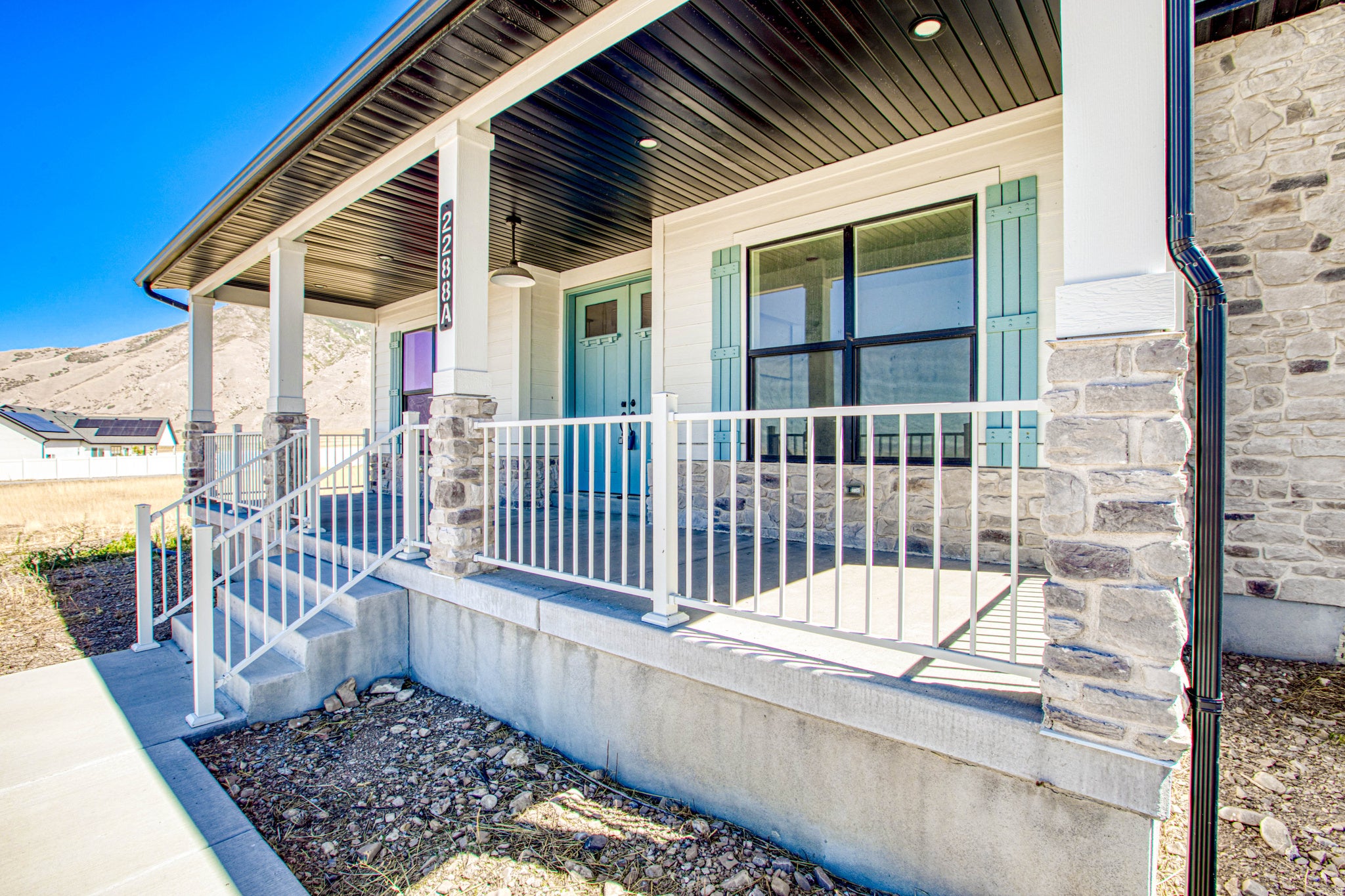Covered front porch with stone-clad columns