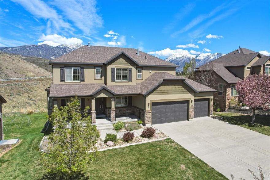 Perched high above the valley in one of Utah's most sought-after mountain communities, 2087 Autumn Fields Lane offers a rare blend of privacy, views, and everyday convenience. Formerly part of the expansive Suncrest master-planned community, this home is surrounded by miles of scenic trails, open canyon space, and sweeping vistas of Mount Timpanogos and Utah Lake-all with no immediate neighbors behind you for added tranquility. Inside, this thoughtfully designed 4-bedroom, 2.5-bath home offers both flexibility and function. The main floor features multiple versatile living spaces, including a formal dining area that can easily serve as an office, music room, or additional sitting area, along with a separate formal living room. A dedicated main-floor office and convenient half bath make remote work effortless. The heart of the home is the spacious living room, where soaring ceilings and a cozy gas fireplace create an inviting atmosphere. The open-concept layout flows seamlessly into the kitchen, ideal for entertaining. Here you'll find stainless steel appliances, abundant cabinetry, granite countertops, a center island, gas cooktop, and double ovens. Perfect for gatherings both large and small. Step outside to the covered Trex deck and take in peaceful mountain views, often accompanied by local wildlife like deer and wild turkey. Upstairs, the oversized primary suite provides a relaxing retreat, complete with a private ensuite bath featuring a double vanity, separate tub and shower, and a generous walk-in closet. Three additional bedrooms and a full bath complete the upper level. The daylight walkout basement expands your living space with a large recreation room, an unfinished fifth bedroom and ample storage including a cold storage room beneath the front porch. The walkout leads to a covered patio overlooking the .27-acre lot, offering even more space to unwind or entertain. Additional highlights include a fully finished three-car garage equipped with an EV charger and premium RaceDeck snap-lock flooring. A charming community park with a picnic area and basketball court sits just across the street. Residents enjoy access to exceptional HOA amenities, including a seasonal pool with hot tubs, lazy river, slide, and kids' splash features, as well as a clubhouse, fitness center, sports courts, high-speed internet, cable TV, and a vibrant calendar of community events. Experience elevated mountain living just minutes from both Salt Lake and Utah Valley's major metropolitan areas. This is more than a home, it's a lifestyle in one of Utah's most coveted locations.
