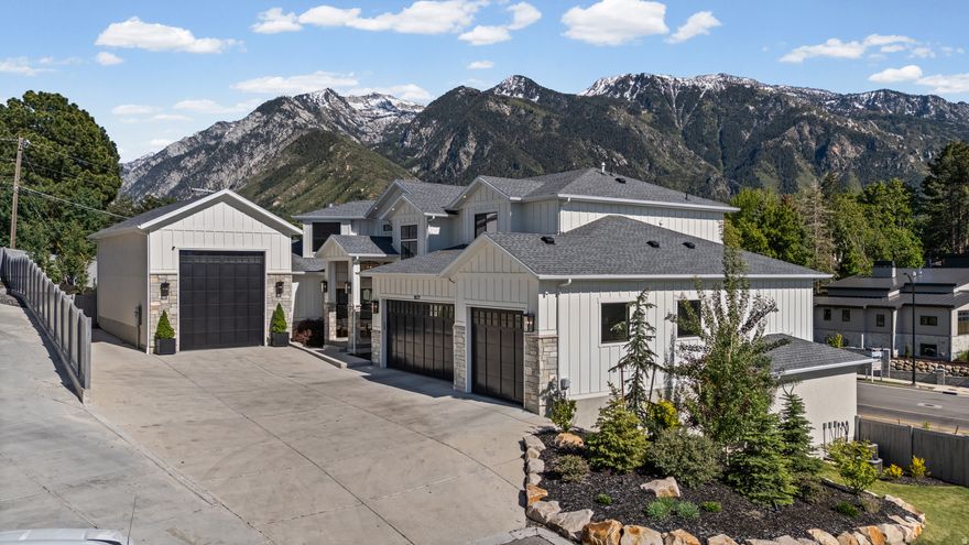 Perched against the breathtaking backdrop of the Wasatch Mountains and nestled near the mouth of Little Cottonwood Canyon, this extraordinary luxury estate offers an unmatched combination of elegance, comfort, versatility, and unforgettable views. From nearly every room, walls of windows frame stunning mountain vistas, creating a serene retreat that feels both private and connected to Utah's natural beauty. Designed for elevated living and exceptional entertaining, the heart of the home features a spectacular chef's kitchen complete with premium high-end appliances, expansive gathering spaces, and seamless indoor-outdoor flow to a covered deck where sunsets over the mountains become part of everyday life. Whether hosting large celebrations, relaxing around the fire pit, enjoying the hot tub under the stars, or entertaining guests with outdoor dining and music, every detail was thoughtfully designed to create memorable experiences The home offers an incredible lifestyle for all, featuring a dream playroom where imagination comes to life, a stunning theater and game room for movie nights and gatherings, and beautifully curated living spaces throughout that blend sophistication with warmth. One of the property's most exceptional features is the attached private ADU / mother-in-law apartment with both interior and exterior private entrances, offering incredible flexibility for multigenerational living, guest accommodations, executive housing, or rental income potential. This beautifully appointed separate living space includes three spacious bedrooms, a full kitchen, living room, mudroom, laundry, and private living quarters that feel like a home of their own. Car enthusiasts, adventurers, and hobbyists will appreciate the expansive RV garage and 6-car garage capacity, complete with ample storage, oversized depth, and additional side parking pad ideal for RVs, boats, trailers, or recreational vehicles. Every inch of this residence showcases quality craftsmanship and intentional design - from luxurious finishes and expansive entertaining spaces to practical amenities that support modern living at the highest level. Combining mountain luxury, privacy, functionality, and breathtaking scenery, this remarkable Sandy estate is truly a rare opportunity to own one of the area's most exceptional homes. Buyer / buyer agent to verify all