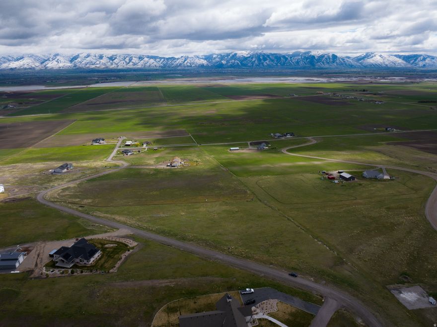 Discover the perfect building spot on this stunning 11.81 acre property, offering breathtaking panoramic mountain views.  This exceptional parcel is ready for your dream home with power and phone stubbed for easy access.  1 well permit with 1.73 acre feet of water currently approved for 1 home, 1.4 acre of yard and 10 head of livestock. Enjoy privacy, open space, and nature while staying conveniently close to necessities with Logan or I-15 only 20 minutes away.  Whether you're looking for a peaceful retreat or an investment opportunity, this land is a rare find! Buyer to verify all information.