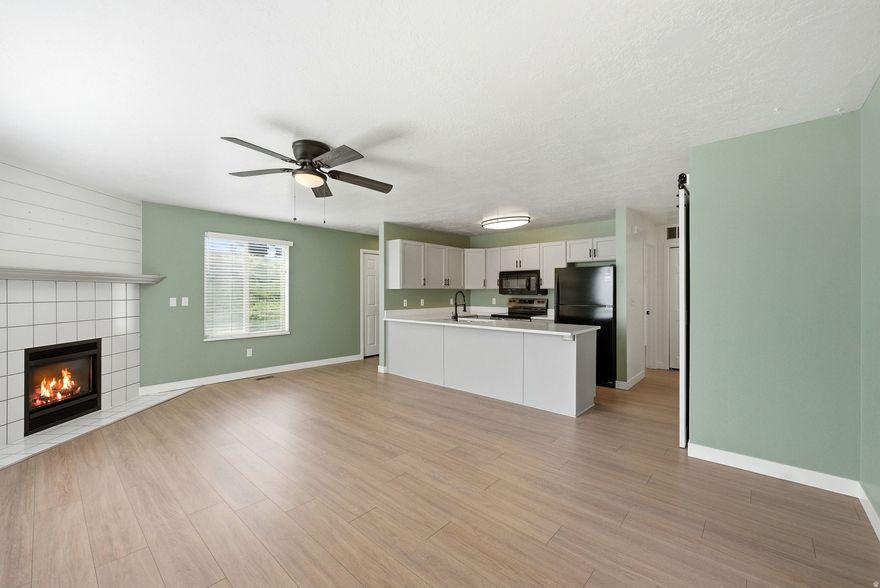 Discover this move-in ready 2-bedroom, 2-bathroom main-level condo nestled in a quiet corner of Sandy. At 949 square feet, the smart layout feels open and inviting, with a fireplace and natural light setting a warm, welcoming tone throughout. The kitchen has been tastefully upgraded, while the generous primary suite features an ensuite bath and walk-in closet. The In-unit laundry adds everyday ease. Out back, a spacious patio offers a peaceful retreat with privacy and no rear neighbors. Covered assigned parking, a nearby community pool, and quick access to shopping, dining, and the freeway make this an unbeatable location. A great opportunity for anyone looking for comfort, convenience, and value in Sandy!