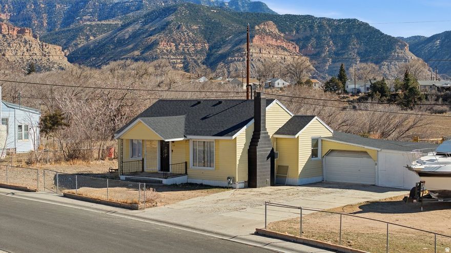 Welcome Home to this beautifully updated East Carbon property offering space, privacy, and thoughtful upgrades throughout. 5Panel Shingles on the Roof  are BRAND NEW for peace of mind! Situated on an Exceptionally Large Yard, this Home delivers a Rare Outdoor Lifestyle with Direct Backyard Access to a Scenic Walking Trail stretching approximately One Mile- Perfect for Morning and Evening Walks. The property also comes with an extra lot zoned for another house! the possibilities are endless here! Inside, You'll find a Brand-New fully Updated Kitchen! Fresh Paint throughout the home, Hardwood floors have been Cleaned & Polished, Adding Warmth and Character. Recent Updates extend BEYOND Cosmetics, with all Electrical and Plumbing updated and the Roof is 1 year old. Offering peace of mind for Years! The Basement adds Flexible Living Space with a Walk-Out Door to the Backyard, a full bathroom and lots of Storage Space. In the Main Living Area you will see the Beautiful Functioning Wood-burning Fireplace that creates a cozy focal point. Outdoors is where this Property Truly Shines. The Expansive Yard offers ENDLESS possibilities for Gardening, Recreation, Animals, or Future Projects. With Small Town Charm, Modern Updates and Outdoor Freedom, You will NOT want to miss this one! Schedule a showing today!