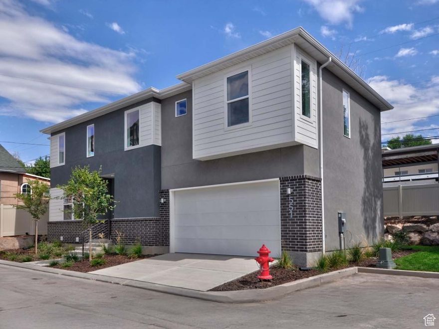 Rare new build on quiet cul-de-sac in an amazing location between University of Utah, downtown, and 9th and 9th. Walking distance to coffee shops, restaurants, and the Trax Red Line that goes straight to the U. This gorgeous modern home is green-certified with a fully-fenced yard, huge patio, AND an attached 2-car garage.  The open concept main floor has a walk-in pantry, dining area, powder bath, and an upscale kitchen with quartz countertops.  Upstairs the master bedroom has TWO walk-in closets, the open flex-space has endless potential, and there are two more bedrooms with walk-in closets. An additional full bathroom and a laundry room complete this perfect layout.  The basement has been exquisitely finished with a stunning fireplace and wet bar and radiant-heated flooring in the bathroom. There is an additional bedroom and plush carpet throughout. Perhaps the best feature of all is the added soundproofing that makes this the perfect place to watch movies or for a quiet home office.  Just minutes to the best restaurants in Salt Lake City and less than 30 minutes to the slopes and Park City. This home is the perfect blend of city-living with all the perks of a modern home. Priced to sell quickly. Check out 3D tour.