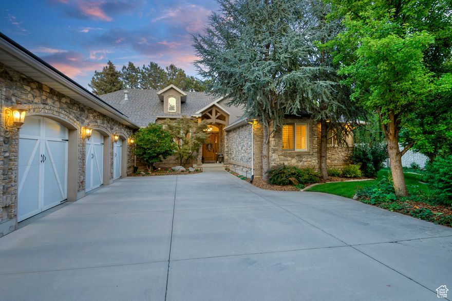 Hidden down a private tree-lined drive in the heart of beautiful East Millcreek sits this custom architectural designed home that feels timeless. Set on an extremely private .41-acre lot, the property boasts a manicured yard, mature trees, and a peaceful babbling stream. Inside, soaring ceilings and expansive windows fill each room with natural light, highlighting the home's thoughtful details and fine craftsmanship. The sprawling 2,963 sq. ft. main floor offers the ease of single-level living, while the impressive 5-car garage provides ample room for vehicles, storage, or a dedicated shop for hobbies. At the heart of the home, a large kitchen flows effortlessly into an expansive family room, creating the perfect space for entertaining or gathering with loved ones. The private master suite is a true retreat, offering comfort and serenity with beautiful finishes and a sense of seclusion. This ideal East Millcreek location offers easy access to Salt Lake City International Airport, is less than 30 minutes from seven world-class ski resorts, and sits just minutes from downtown Holladay, fine dining, and shopping. Downstairs, the expansive 2,880 sq. ft. basement provides plenty of room to raise a family or host guests, with each bedroom featuring its own ensuite bathroom for comfort and privacy. The open-concept lower level also offers space for a home theater setup, fitness area, or game room-perfectly blending luxury and functionality without sacrificing flow. This rare East Millcreek retreat combines timeless architecture, modern amenities, and unmatched privacy. Schedule your private tour today and experience all this extraordinary home has to offer.