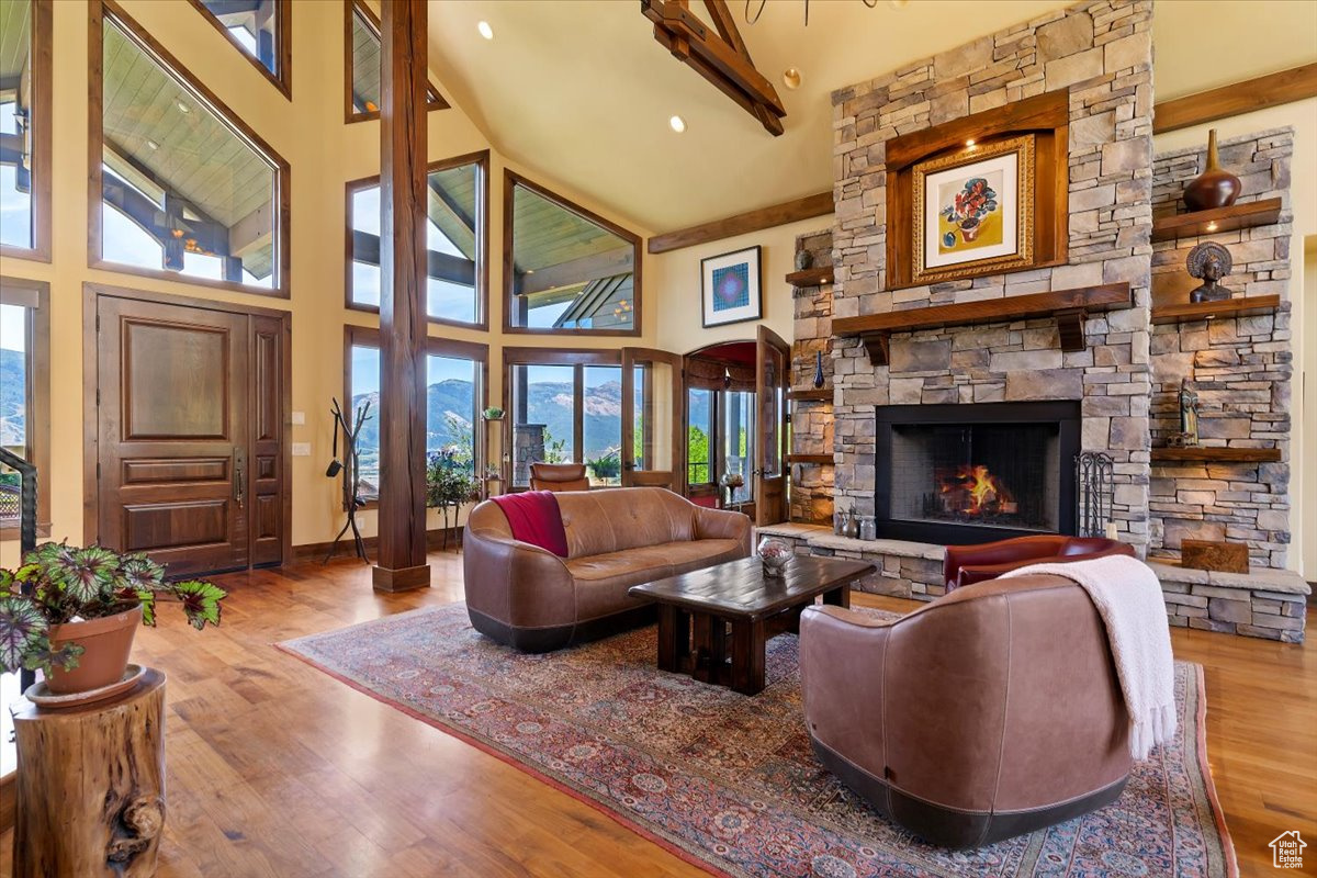 Luxury Mountain Living. Picture yourself savoring sunset views from the deck after a day on Pineview Reservoir, or unwinding by the outdoor stone fireplace after carving fresh powder at Snowbasin or Powder Mountain. Nestled in the prestigious Highlands at Wolf Creek, this 4,452 sq ft luxury retreat-designed and built by Buxton, Inc.-offers 4 bedrooms, 3.5 baths, and panoramic vistas of Snowbasin, Nordic Valley, Pineview, and the Ogden Valley. The open-concept living, dining, and gourmet kitchen boast cathedral ceilings, a custom hand-blown glass chandelier, a dramatic floor-to-ceiling stone fireplace, custom Alder wood cabinetry, granite countertops, and Wolf appliances. The main-level primary suite features its own stone fireplace, spa-inspired bath with soaking tub, and a sauna. Upstairs, you'll find a second en-suite primary, plus a private study with custom floor-to-ceiling cabinetry. Luxury finishes include walnut floors, handmade 10-foot doors, and custom lighting throughout. The lower level offers two additional bedrooms, a large 3/4 bathroom, a theater room with velvet curtains and leather seating, new HD projector, Sonos surround sound, and a cozy fireplace-plus space for a pool table or game area. The radiant heat flooring keeps it warm in the winter and even without air conditioning, the lower level stays cool during the summer months. Enjoy year-round outdoor living on the expansive patio with built-in grill, stone fireplace, and private hot tub. A heated 3-car garage with storage, meticulously landscaped .88-acre lot, pre-listing inspection, and option to purchase two additional lots make this an exceptional mountain home.