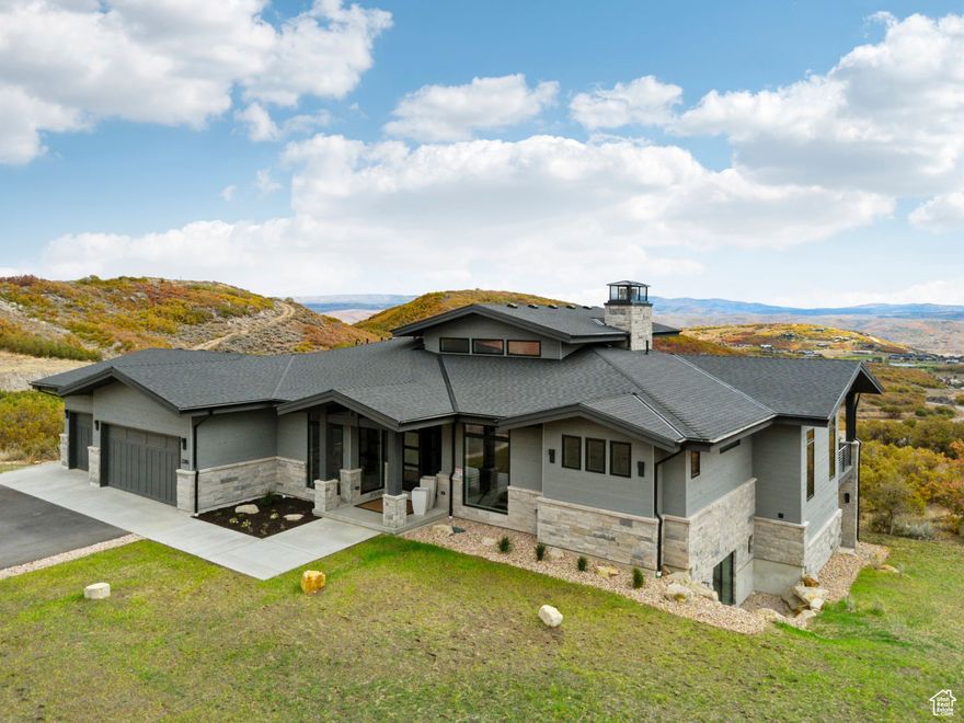 Perched high above Jordanelle Lake in the sought-after Golden Eagle community, 2280 E Outlaw Road is more than a home-it's a front-row seat to Utah's most breathtaking scenery. With the slopes of Deer Valley Resort just minutes away and the charm of Park City's Main Street close by, this retreat delivers both adventure and tranquility in equal measure.  This 5-bedroom, 5-bathroom residence artfully blends alpine architecture with sleek, modern design. Inside, light floods the open-concept living space through expansive windows that perfectly frame dramatic views of Mount Timpanogos and the Uinta Mountains. Vaulted ceilings and clean lines create a spacious yet welcoming atmosphere, ideal for gathering with friends or enjoying a quiet evening by the fire.  The heart of the home-a chef's kitchen-is outfitted with top-tier appliances, quartz counters, and an oversized island that invites connection.   The luxurious primary suite offers a peaceful escape, with a spa-style bath and private views that stretch for miles.  Entertainment is elevated on the lower level, where you'll find a second kitchen that makes hosting effortless and an indoor theater that delivers a true cinematic experience-perfect for movie nights, sports, or gaming. Step outside to multiple deck spaces designed for sunset-watching and stargazing.  Whether you're entertaining, exploring, or simply unwinding, this home is your launchpad for all-season mountain living.  2280 E Outlaw Road is where refined style meets rugged beauty-an exceptional opportunity in one of Utah's most dynamic and scenic mountain communities.