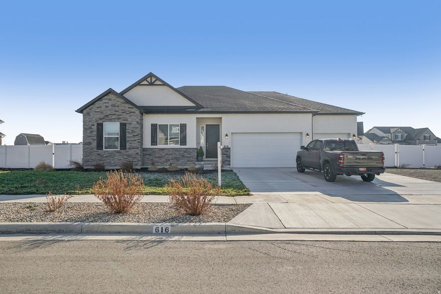 Like-new 2022 rambler on a half-acre lot in a quiet Grantsville neighborhood with beautiful views. This well-maintained single-level home offers 3 bedrooms, 2.5 baths, and 2,393 sq ft of finished main-level living, plus an additional 2,393 sq ft unfinished basement ready for future expansion. Enjoy thoughtful upgrades including quartz countertops, an induction stove, generous pantry, central vacuum, and a jetted tub. The oversized garage can accommodate up to four vehicles if desired. Owned solar panels with backup battery are included free and clear, helping keep utility costs low. The partially landscaped yard features a shade tree, three fruit trees, and raised garden boxes, with plenty of room to customize and grow. A rare opportunity to enjoy newer construction, space, and a peaceful feel, just minutes from town.