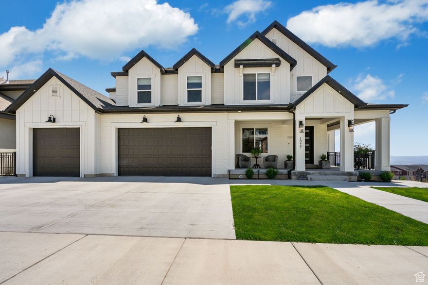 Farmhouse charm meets city life in this beautifully crafted home nestled in Traverse Mountain, right in the heart of Utah's Silicon Slopes. With breathtaking views of Utah Lake and the valley beyond, this inviting home blends timeless character with modern comfort. Step inside to an open-concept layout centered around a grand two-story fireplace-a perfect gathering spot on cozy evenings. The main-floor primary suite is a peaceful retreat with a spa-inspired bath featuring a freestanding soaking tub, oversized shower, dual vanities, and custom cabinetry for storage. The heart of the home opens to a farmhouse-style kitchen designed for both function and warmth, ideal for hosting family and friends. Downstairs, you'll find room for every kind of living-enjoy a gym, guest bedrooms, and a charming second full kitchen as part of a separate two-bedroom ADU. Whether for guests, extended family, this second kitchen adds versatility and value. Outdoors, relax on the expansive deck while watching stunning sunsets and views of Mount Timpanogos and Utah Lake. This amazing home won't last, schedule a private showing today. Buyer/Broker to verify all.