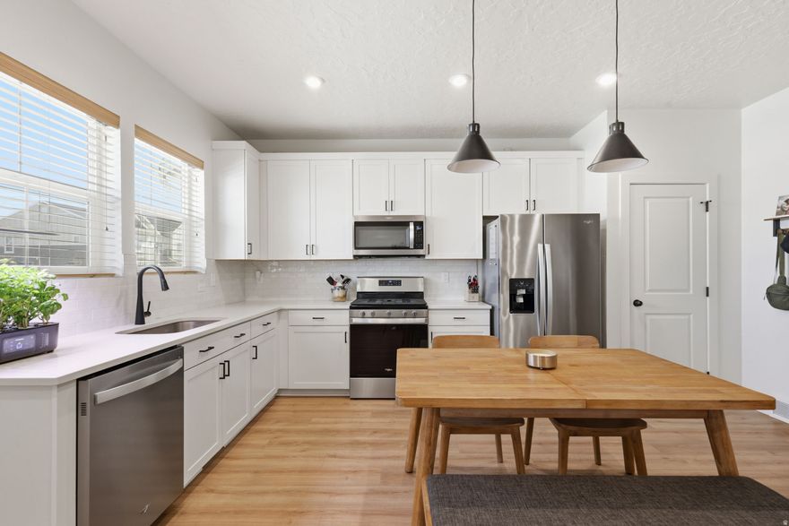 Discover exceptional value in this like-new home, an incredible opportunity you won't want to miss. Step inside to an inviting open floorplan filled with abundant natural light and stunning mountain views from both the front and back of the home. With no rear neighbors, you'll enjoy added privacy and a spacious, easy-to-navigate driveway-no tight maneuvering like many other townhome communities. The oversized primary suite truly stands out, offering more space than many single-family home bedrooms. The ensuite bath features a double-wide shower, dual vanities, and generous storage, while every bedroom includes its own walk-in closet. The kitchen is both stylish and functional, showcasing upgraded extra-tall cabinetry, quartz countertops, a gas range, and modern black hardware that carries throughout the home. Downstairs, the large basement living room provides the perfect setting for entertaining, relaxing, or creating your ideal gathering space. This home is also packed with thoughtful tech upgrades, including ethernet ports in every bedroom, the main floor, and basement, a WiFi-enabled garage door, and a water softener for added convenience. Enjoy a vibrant, family-friendly community with access to walking trails, a pickleball court, three playgrounds, and a neighborhood pool. Outdoor enthusiasts will love the nearby wildlife area with hiking and biking trails just moments away. Conveniently located just minutes from shopping and dining-only 3 minutes to Walmart, 7 minutes to Costco-and ideally positioned between Eagle Mountain and Saratoga Springs for quick access to Mountain View Corridor.