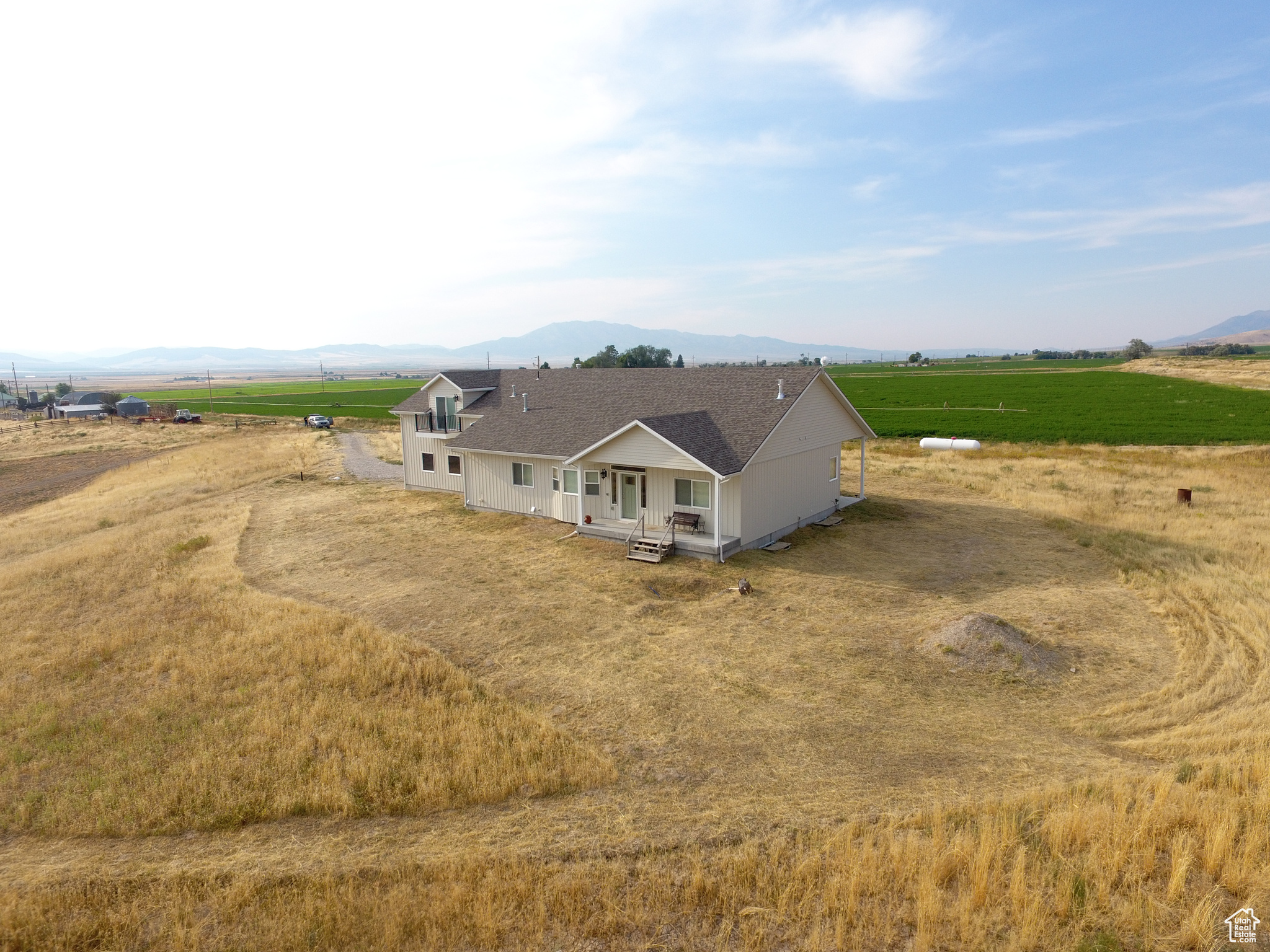 Private 11+ acres with breathtaking mountain views. This 4,181 sq ft home offers 3 bedrooms and 3 bathrooms, including a spacious primary suite with a tray ceiling, his and hers walk-in closets, and a luxurious bathroom with a separate shower and soaking tub. The large, open kitchen features granite countertops and a walk-in pantry. Both the main floors and basement boast 9-ft ceilings; the basement is framed for two additional bedrooms, a full bath, and a generous family room, with extra storage and a secure safe room. An oversized attached 3-car garage provides ample parking and workspace. Full RV hookups are available on the cement pad adjacent to the house. Above the garage, a 500 sq ft ADU offers guest or rental space, complete with a balcony that provides a relaxing atmosphere. The horse-friendly property features pasture ground, ideal for equestrian pursuits. You will enjoy the covered back patio or front porch, both offering sweeping views. This property combines spacious comfort, rural tranquility, and endless potential for outdoor living and growth.