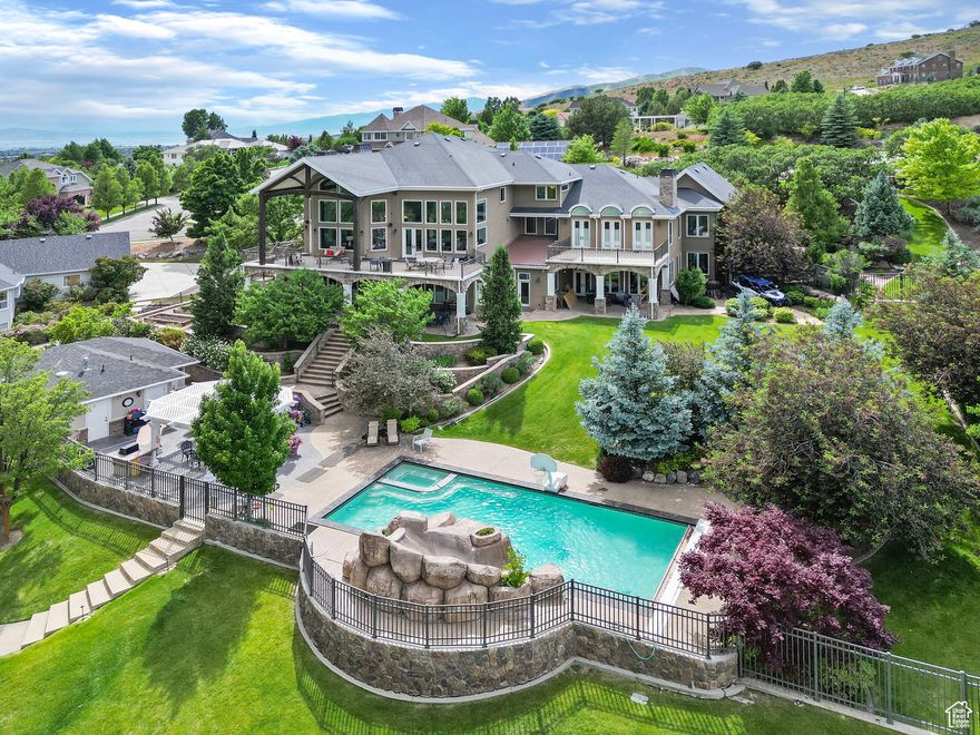 Breathtaking Alpine estate with sweeping views of Lone Peak mountains and Alpine valley. Nearly one acre of luxury living featuring five ensuite bedrooms, two private offices, an art studio, a gym with sauna and steam shower, and three laundry rooms for ultimate convenience. A gourmet kitchen features double islands, high-end appliances, and an effortless flow into the main gathering room, which opens onto an oversized deck - perfect for entertaining while taking in the sweeping mountain backdrop. The backyard oasis features a swimming pool with a built-in hot tub, a pergola, an outside bathroom, and an integrated sound system. A detached auxiliary garage with an 11-foot door and a separate entrance provides excellent space for recreational vehicles or a workshop. This is more than a home-it's a lifestyle of beauty, comfort, and connection-price Improvement, which makes today the perfect day to schedule a showing.