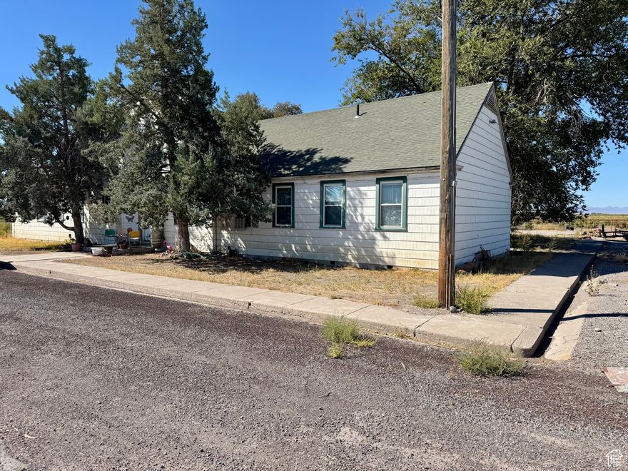Historic church building that has been converted to a single family home, sitting on a large 12.5 acre site. Located on the NW outskirts of Delta, with wide open space, beautiful views in all directions and a low-traffic road. The gym and stage are still intact and make a great open space inside. This property has so much potential! The family has loved living here and are excited for the next owners to have a piece of Millard County history. This property is zoned Ag1, which allows for residential lots of 1 acre or larger, in case someone would like to break down the property into smaller lots. Solar panels are included (installed 2023). Map outline is approximate. It includes the property from 7500 North up to the home.