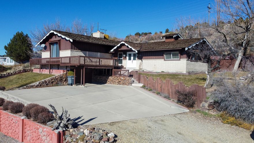 Nestled in a serene neighborhood, this charming house offers an unparalleled lifestyle with breathtaking views of the golf course and the valley below. Step onto the expansive deck to soak in the stunning scenery, perfect for morning coffee or evening gatherings. The large private patio at the back invites you to enjoy outdoor entertaining or peaceful moments in the sun. Inside, the thoughtful home layout ensures comfort and functionality, making it ideal for both family living and entertaining. Just minutes from the majestic mountains, you'll find endless opportunities for hiking and adventure. With walking and bike paths nearby, you can explore the beauty of the area at your leisure. This is more than just a home; it's a lifestyle waiting for you to embrace.