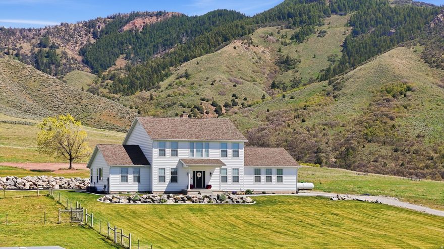Welcome to the kind of home you don't just buy... you feel the moment you arrive. Set just outside Malad City near New Canyon and Devil's Creek, this property delivers what so many are searching for - wide-open space, privacy, and uninterrupted mountain views in every direction. Sitting on 4.6 acres under expansive Idaho skies, this 2021-built home offers a rare blend of modern comfort and peaceful surroundings. Inside, the home was designed to bring people together. The open-concept layout centers around a striking 10-foot kitchen island with seating for eight - perfect for slow mornings, shared meals, and effortless entertaining. As the day winds down, the wood-burning fireplace becomes the heart of the home, creating a warm, inviting atmosphere that makes every evening feel grounded and relaxed. With over 3,500 square feet, the home features 4 bedrooms, 3.5 bathrooms, and two additional flex spaces ideal for offices, creative rooms, or potential bedroom conversions - giving you the freedom to make the space your own. The primary suite has been thoughtfully updated with upgraded tile, a new vanity, and a refreshed shower, offering a clean, spa-inspired retreat. Step outside and experience how fully this property has been prepared. The yard has been professionally graded and established with a full sprinkler and drip system, while concrete work - including the driveway, walkways, back patio, and RV pad - adds both function and a polished finish. The property is also equipped for a variety of uses, with power and water run to outbuildings and a designated animal area. Rock walls and additional landscaping enhance both usability and curb appeal, creating a setting that's as practical as it is visually striking. Located just 15 minutes from town, this home offers a seamless balance of accessibility and escape - close enough for convenience, yet far enough to enjoy quiet, open surroundings. If you've been looking for space to breathe, views that go on for miles, and a home that's already dialed in... this is where it all comes together.Don't forget to check out the link of the video and 3D tours!  Buyer to verify all information.