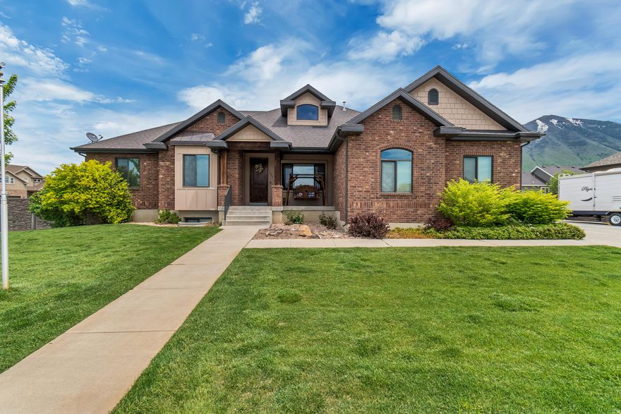 Stunning brick rambler in Salem's desirable Meadows at Mount Loafer neighborhood, set on over a third of an acre with breathtaking mountain views right from the front yard. Step inside to a formal living room with vaulted ceilings and abundant natural light. The heart of the home is an expansive kitchen featuring rich knotty alder cabinetry, granite countertops, an island with seating, and a built in desk area, all flowing seamlessly into the  dining area. The spacious living area impresses with soaring ceilings and an abundance of natural light. The primary bedroom offers an ensuite bathroom with dual sinks, a separate soaking tub and walk in shower, and a generous walk in closet. Downstairs, the finished basement expands the home considerably with a large living area, a kitchenette, three bedrooms, a full bathroom, a separate entrance, and extensive cold storage, ideal for guests or multigenerational living. Outside, a three car garage, dedicated RV parking, and a fully fenced and landscaped backyard with a covered deck and mature trees complete the home. Located near East Salem Canal Road, the Loafer View Recreation Complex, and convenient access to shopping, dining, and everyday essentials. Measurements provided as a courtesy only, buyer to verify all info.