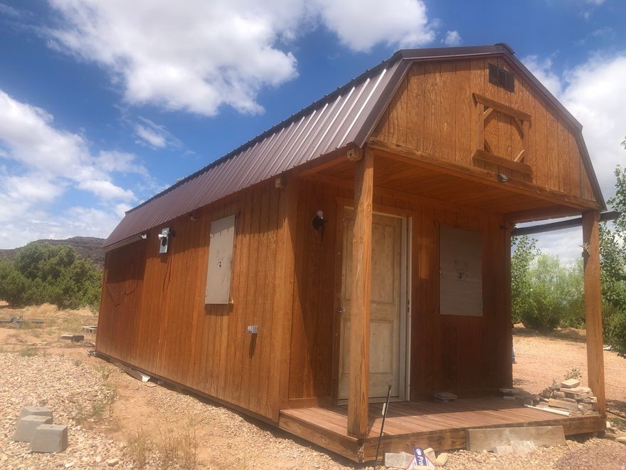 Also includes parcel numbers 00-0014-5213, 00-0014-5239, 00-0014-5221. 40 acres with a newer 12 X 32 cabin w/a/c unit, cabin also has three security shutters to protect windows, septic system for two trailers with power and water hookups, well hooked to watering system for trees and trailer hookups, 200 amp breaker panels in well house and cabin, 10 X 10 Storage shed, 10 X 10 well house, pavilion on cement pad for get togethers, also includes carport. Address is approximate.