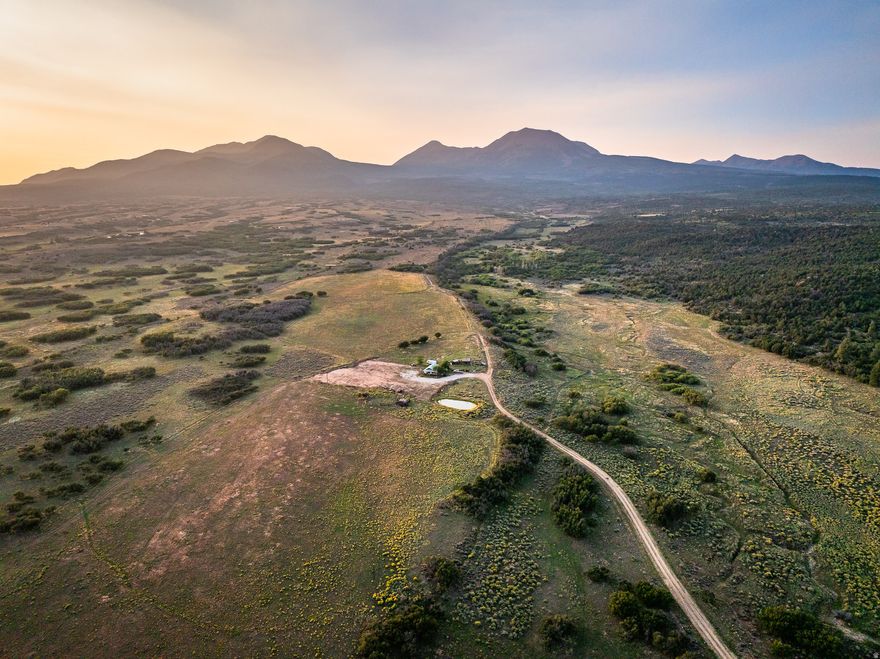Set against the dramatic backdrop of southeastern Utah's alpine transitions, this 105-acre estate parcel represents a rare convergence of water, wilderness, and proximity. Anchored by a natural spring system, the land carries a defining element few properties can claim: a consistent, living water source that shapes both the character and long term viability of the property. The spring supports the potential for private ponds, curated landscapes, and a self sustaining lifestyle rooted in authenticity and independence. Bordering expansive United States Forest Service lands, the property enjoys direct access to thousands of acres of protected terrain. This adjacency ensures enduring privacy and an uninterrupted connection to the surrounding environment, offering a seamless extension of the land into the wilderness beyond. Despite its sense of seclusion, the property is ideally positioned just outside Moab, placing world class recreation, dining, and air access within easy reach. Iconic destinations including Arches National Park and Canyonlands National Park are 40 minutes away, while the alpine terrain of the La Sal Mountains rises prominently to northwest. For extended travel and recreation, Telluride is within a scenic drive, connecting the property to one of the region's premier mountain destinations. The land itself is both expansive and usable, with a composition well suited for a private compound, legacy ranch, or a limited, design forward development that responds to the natural contours and water features of the site. Properties of this caliber, defined by live water, adjacency to protected lands, and proximity to Moab's global draw, are seldom available. This is an opportunity to secure not only acreage, but a generational asset grounded in the enduring appeal of the American West.