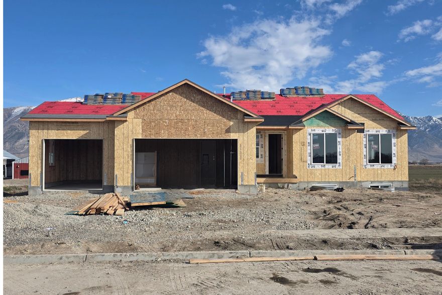 Welcome to the Emerson  Your Dream Home Awaits! Discover the perfect blend of elegance and comfort in this three-bedroom, two-and-a-half-bath beauty in the heart of charming Elwood, Utah. The master suite is a true retreat, featuring a spa-like bathroom with a marble-surrounded tub and shower, dual vanities, and a dreamy walk-in closet. Entertain with ease in the gourmet kitchen, complete with custom cabinetry, quartz countertops, and a spacious pantry-perfect for family meals and weekend gatherings. The unfinished basement gives you the freedom to design the ultimate game room, home theater, or hobby space. Car enthusiasts and storage lovers will love the third car garage door, while the half-acre lot provides room for outdoor fun, gardening, or simply relaxing under the Utah sky. * Pictures may not be of actual home. Some features may not be included.    Square footage figures are provided as a courtesy estimate only and were obtained from the building plans.  Buyer is advised to obtain an independent measurement.