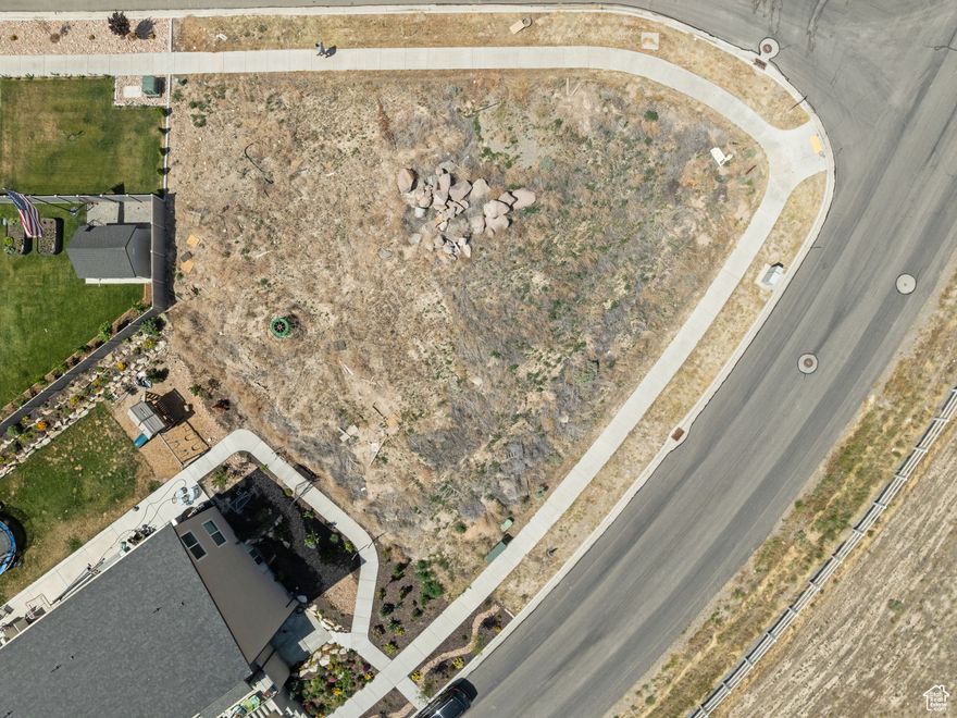 It's easy to imagine your custom built lake house from this view lot. This corner lot offers panoramic lake views. Situated within the beautiful Wellspring Subdivision, this lot is ready for your custom build.  Bring your own builder.  Wellspring is a Parade Home neighborhood (Firefly Homes). There is no HOA in the Wellspring subdivision. Marina Park, the public marina, is located less than 4 minutes away. Talons Cove Golf Club is less than 2 miles away and offers gorgeous landscape views of the lake and mountains. This lot offers Resort-like living without the monthly dues!