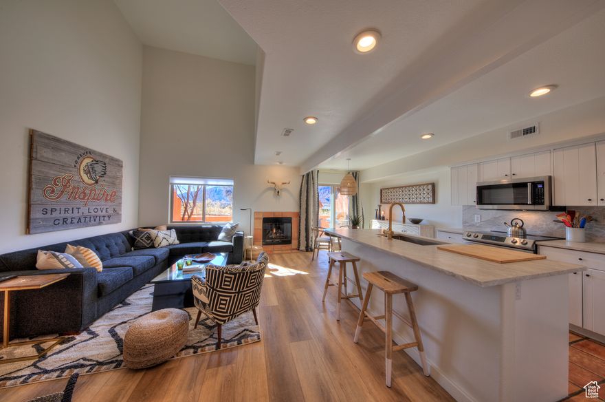 REFINED TOWNHOME ON THE GREEN  This classy townhome has a refined remodel opening up the kitchen and living area to modern standards.  Masterfully designed and decorated with a southwestern boho vibe, comprising an inclusion package with most of the furnishings and artwork included.  Elegant quartz counters and backsplash, desirable wood-grain flooring intermixed with the original Saltillo tile artfully blends these styles together. The vast vaulted ceilings of the living area intrigues the sense of grandeur, while maintaining the cozy appeal. The main level also integrates a bathroom with a bodacious walk-in shower, formal entry, and one-car garage. The upper-level embraces two comfortable and pleasant bedrooms, both with inviting king beds and shared full bathroom. The patio overlooks the Moab Golf Club's 16th hole and the towering Moab Rim- an incredible place to dine and relax. After a long day on the trail, make sure to take a dip in the Castillo del las Rocas community pool!  Already a thriving short-term rental, this exceptional home has the flexibility to be your primary residence, second home, or continued flourishing rental.
