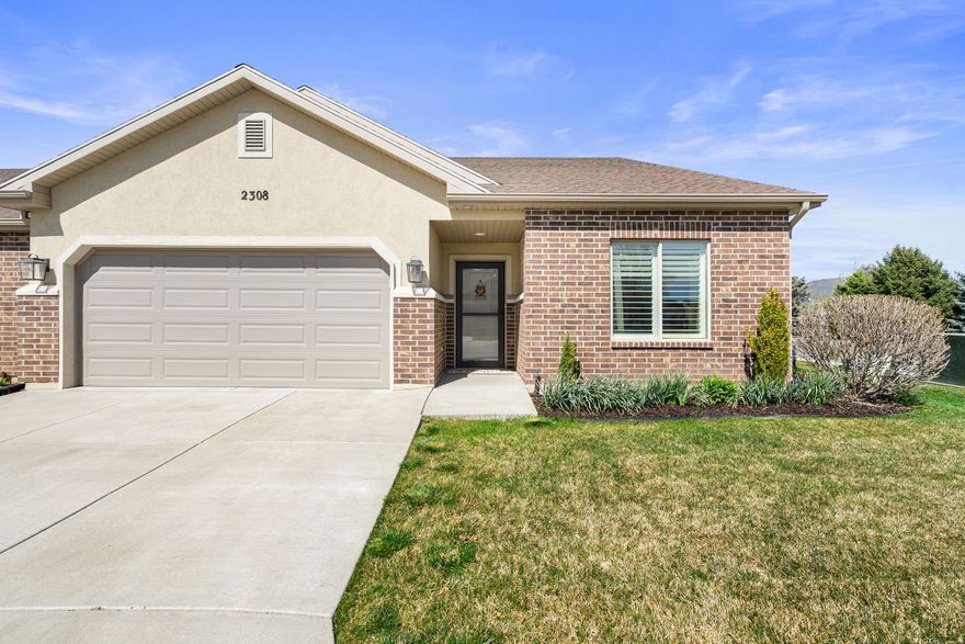 RARE 55+ PATIO HOME WITH EXTRA SPACE & MOUNTAIN VIEWS! This upgraded, south-facing end-unit patio home offers added square footage for a more open, comfortable feel and is located in a quiet, newer community. Vaulted ceilings, large windows, and a cozy gas fireplace create a bright, inviting main living space. The kitchen features black stainless appliances, a gas convection range, granite countertops, a large island, soft-close cabinetry, engineered hardwood floors, and excellent storage with both a corner pantry and separate oversized pantry. The spacious primary suite includes a sitting area, walk-in closet, and a well-appointed bath with dual sinks, quartz countertops, a walk-in shower, and tile flooring. A second bedroom with an adjacent full bath offers flexible use for guests, an office, or hobbies. Additional highlights include a large laundry room with cabinets and counter space, a finished 2-car garage with overhead storage, and a private patio with beautiful mountain views. Clean, well-maintained, and move-in ready-perfect for low-maintenance living. Buyer to verify all information. Square footage provided as an estimate.