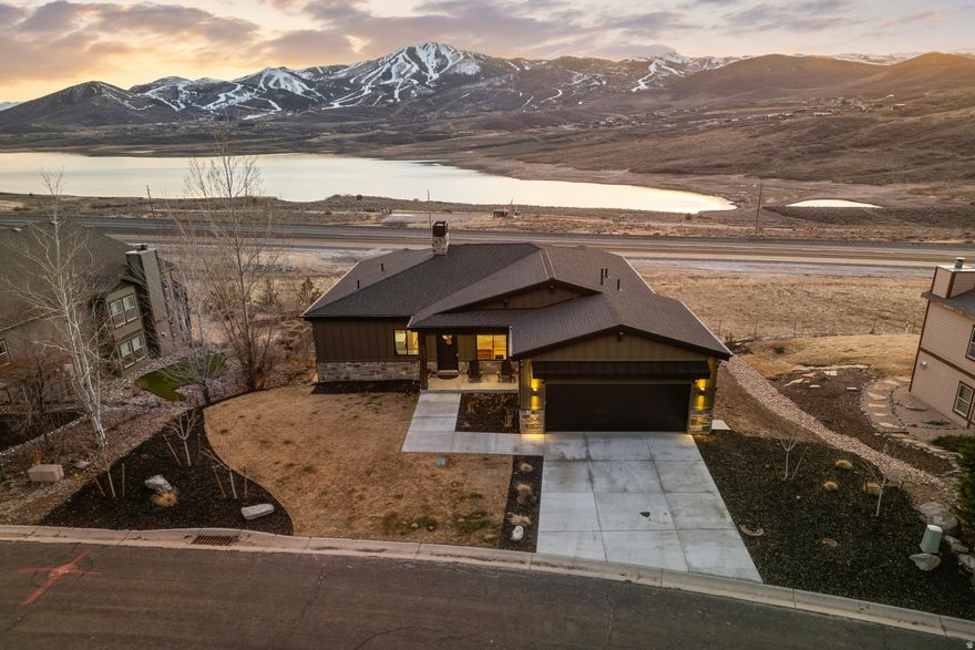 Serene Mountain Retreat with Unparalleled Views An extraordinary opportunity awaits you as you experience the ultimate premier setting in this breathtaking Deer Mountain retreat, beautifully designed to offer panoramic, unobstructed views of Deer Valley East Mountain Resort and Jordanelle Reservoir.   This stunning home features large, open living spaces with vaulted 10 ft. ceilings , floor to ceiling stone fireplace, expansive windows, sunny decks perfect for entertaining, stargazing, or enjoying the sunsets.   The interior welcomes a warm design with the timeless allure of the mountains.  A beautiful gourmet kitchen completed with cabinets, pantry, large island with granite countertop, and ample cooking space to entertain your guests. The master suite on the main level features a stunning view, cozy fireplace, a deck for relaxing and taking in fresh air, a walk-in shower with a freestanding soaking tub and a large walk-in closet.  Downstairs you'll find 9 ft. ceilings, fireplace, living space, 3 bedrooms, 2 bath, wet bar area and walk out basement connecting to a perfectly placed deck with a view.  Just minutes from the legendary slopes of Deer Valley and Park City Mountain, you're perfectly placed for both adventure and downtime. After a day on the mountain, head into historic Main Street for great food, and entertainment. When summer rolls in, Jordanelle Reservoir becomes the playground-think boating, paddle boarding, fishing, and lakeside fun, with scenic hiking and biking trails waiting right outside your door.  Features in this home include an oversized epoxy floor garage, driveway roughed in and set up for driveway heating, Instantaneous water heater, washer and dryer on both levels, roughed in hot tub power on lower deck, air purifier, steam humidifier and water softener.  This is a rare opportunity to own your dream home - A mountain masterpiece designed to be surrounded by nature and natural beauty.