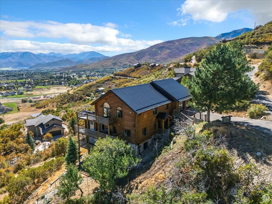 Solid 5-bed, 2-bath cabin with unbeatable views of the Heber valley, including deer Creek reservoir in the distance. Major upgrades in the last 3 years: new air-conditioning mini-splits and new boiler radiant heating, which is the most efficient way to keep the home cool in the summer and warm in the winter, carpet, roof, water softener, whole-house Generac, Swedish hot tub, and epoxy garage floors! New front, downstairs, and garage doors. New bedroom windows (except downstairs). Strong bones, incredible setting-perfect for year-round living or a mountain getaway. Hurry this home won't last long! Schedule your showing today!