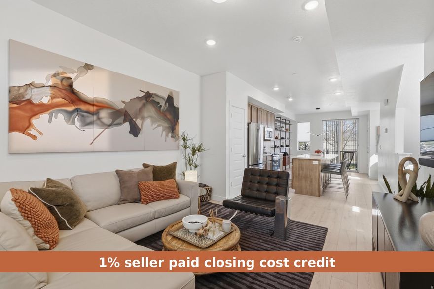 SELLER IS OFFERING a 1% CLOSING COST CREDIT. Meticulously maintained and built in 2024, this stunning two-bedroom end-unit townhome offers abundant natural light, enhanced privacy, and a thoughtfully curated selection of upgrades. Large, captivating windows fill the home with light, highlighting the modern finishes throughout.  The well-designed floor plan includes a convenient half bath on the main level, while the primary suite features dual sinks for added comfort and functionality. The kitchen is beautifully appointed with quartz countertops, stainless steel appliances (electric range, microwave, and dishwasher), and modern shaker-style cabinetry, all complemented by durable hardwood laminate flooring extending throughout the main level.  Enjoy mountain views from the kitchen, dining area, and primary bedroom, creating a serene and elevated living experience. The open-concept main level features 9-foot ceilings and a spacious layout, ideal for entertaining or relaxing, centered around an oversized 8-foot kitchen island.  Additional highlights include a private deck, a two-car tandem garage with ample storage, and fiber internet availability. Designed with efficiency in mind, this home was built by MacArthur Homes, a 2024 Best of State award winner recognized for quality construction and thoughtful design.  Ideally located just minutes from downtown Salt Lake City, Salt Lake International Airport, and with quick access to I-15, I-215, and I-80, this home offers both convenience and connectivity. Outdoor recreation is easily accessible with nearby canyons and endless opportunities for adventure.  Move-in ready and perfectly situated - this home truly has it all. Square footage figures are provided as a courtesy estimate only and were obtained from prior MLS .  Buyer to verify all.