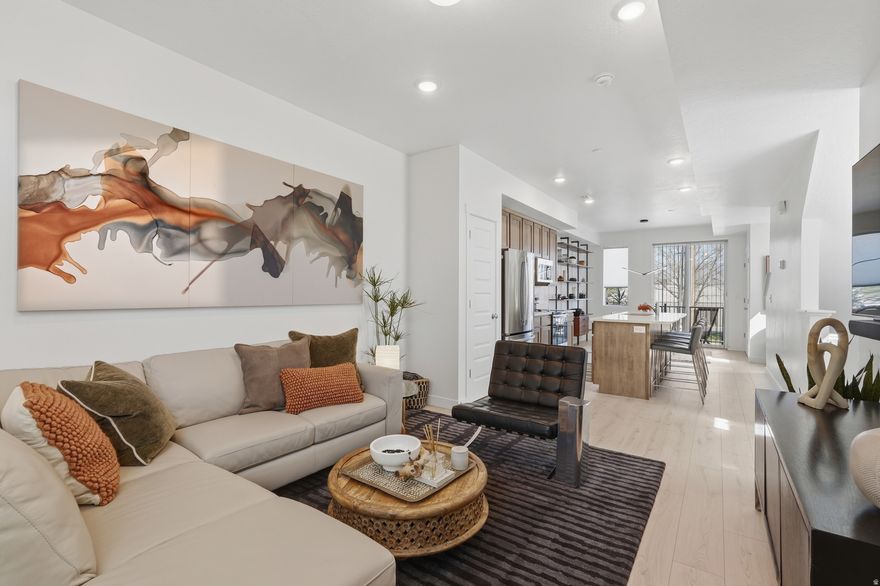 Meticulously maintained and built in 2024, this stunning two-bedroom end-unit townhome offers abundant natural light, enhanced privacy, and a thoughtfully curated selection of upgrades. Large, captivating windows fill the home with light, highlighting the modern finishes throughout.  The well-designed floor plan includes a convenient half bath on the main level, while the primary suite features dual sinks for added comfort and functionality. The kitchen is beautifully appointed with quartz countertops, stainless steel appliances (electric range, microwave, and dishwasher), and modern shaker-style cabinetry, all complemented by durable hardwood laminate flooring extending throughout the main level.  Enjoy mountain views from the kitchen, dining area, and primary bedroom, creating a serene and elevated living experience. The open-concept main level features 9-foot ceilings and a spacious layout, ideal for entertaining or relaxing, centered around an oversized 8-foot kitchen island.  Additional highlights include a private deck, a two-car tandem garage with ample storage, and fiber internet availability. Designed with efficiency in mind, this home was built by MacArthur Homes, a 2024 Best of State award winner recognized for quality construction and thoughtful design.  Ideally located just minutes from downtown Salt Lake City, Salt Lake International Airport, and with quick access to I-15, I-215, and I-80, this home offers both convenience and connectivity. Outdoor recreation is easily accessible with nearby canyons and endless opportunities for adventure.  Move-in ready and perfectly situated - this home truly has it all. Square footage figures are provided as a courtesy estimate only and were obtained from prior MLS .  Buyer to verify all.