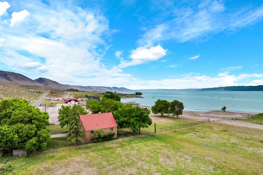 This charming Bear Lake beachfront home is the epitome of lake living. With 2977 sq ft of living space, this home offers plenty of room for the whole family to spread out and enjoy the magnificent lake views. With 5 bedrooms and 1 12 baths, and almost a half acre of land, there is ample space for guests and entertaining. The most impressive features of this home is the 100 ft of sandy beachfront, providing unparalleled access and views of the beautiful Bear Lake. Imagine waking up each morning to the gentle sound of waves lapping at the shore and enjoying your day overlooking the water. The best part? This home is free of any pesky HOA fees, giving you the freedom to make this home truly your own. Don't fight the lines at the marina, launch your boat right from home. With all of these amazing features and more, this Bear Lake beachfront home is a must-see for anyone looking for the ultimate lakefront living experience. Come get your Bear Lake Getaway today!