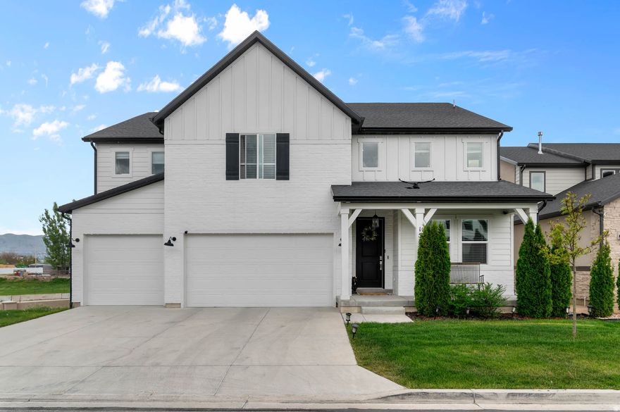 Beautifully designed 5-bedroom, 3-bathroom home with an open and functional layout. The main floor features soaring two-story windows that fill the home with natural light, a versatile flex room, a full bathroom, and a spacious main-level bedroom. The kitchen showcases craftsman-style white cabinetry, white quartz countertops, a contrasting taupe subway tile backsplash, stainless steel appliances, a range hood, and a convenient butler's pantry. Upstairs you'll find 3 additional bedrooms, a spacious owner's suite with a spa-inspired bathroom, and a dedicated laundry room. The unfinished basement offers plenty of room to grow and customize to fit your needs.