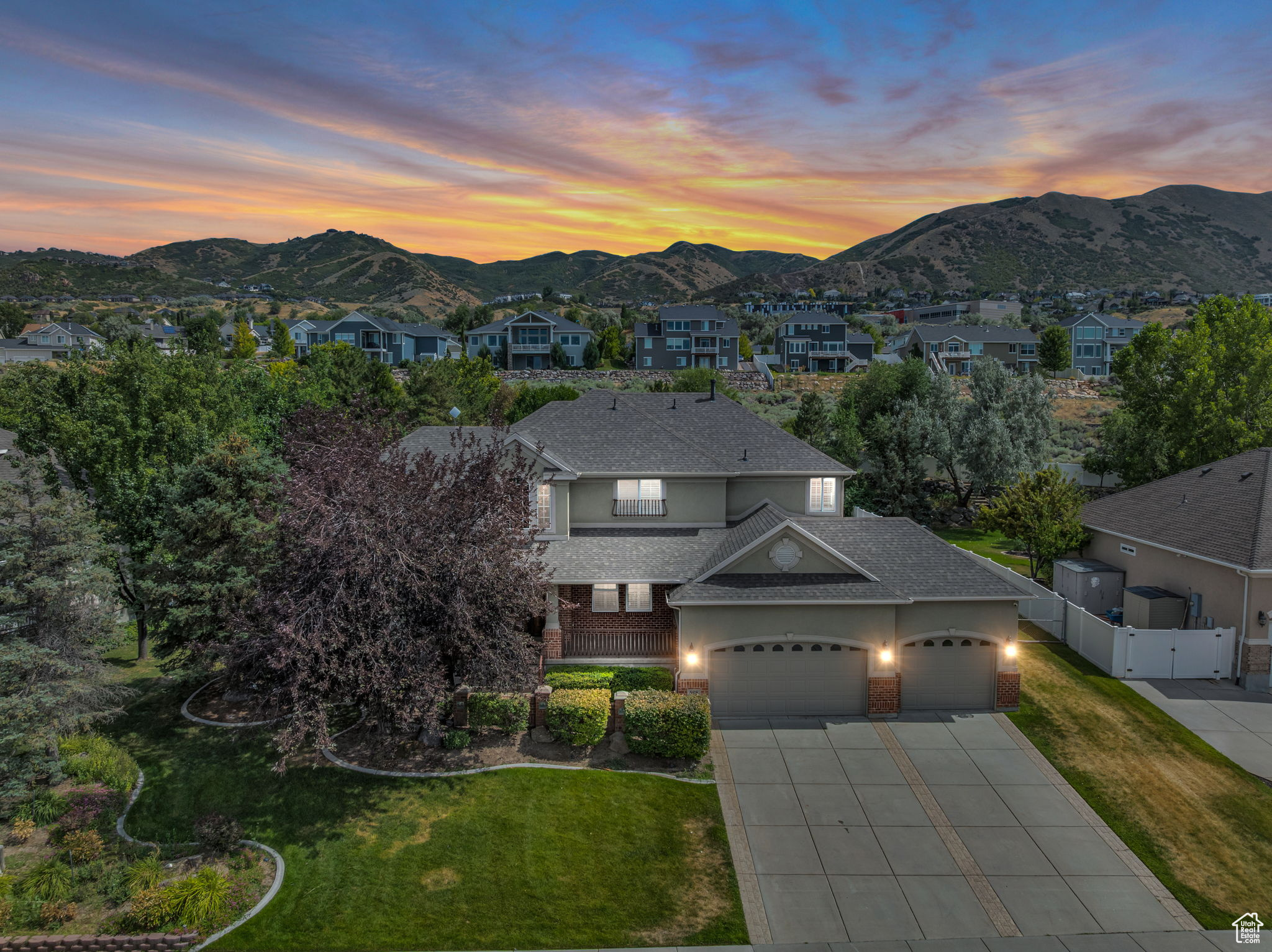 Nestled in Draper's prestigious Corner Canyon district, this 5,227 sq ft home has been refreshed with new paint and flooring throughout, offering the perfect blend of elegance, comfort, and location. Featuring six bedrooms, including an upstairs master suite, and four and a half bathrooms, it provides generous space for family living and entertaining. Vaulted ceilings, open living areas, a spacious kitchen, a formal dining room with a butler entry, and a den off the main entrance create an inviting and functional layout. The fully finished basement includes a large family room and a complete second kitchen, making it perfect for extended stays or large gatherings. Set on nearly half an acre, the property boasts a large, fenced yard with mature trees and a sport court-ideal for outdoor fun and relaxation. For added comfort and accessibility, the main level offers a bedroom with a walk-in tub, and a custom chair lift that is provided with the home for the main staircase but not installed-adds versatility for multi-generational living. Outdoor enthusiasts will love the close access to the Porter Rockwell Trail, offering miles of scenic walking, running, and biking paths. The home is also conveniently located near freeways, shopping, additional trails, parks, and top-rated schools and easy access to both Salt Lake and Utah County.