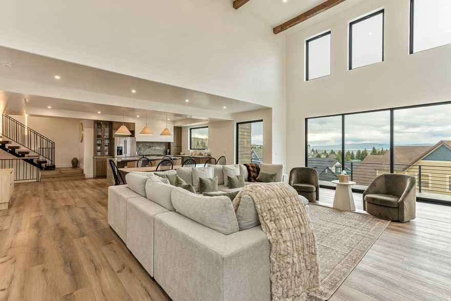 Luxury Bear Lake Retreat with Panoramic Views that's Fully Furnished with Turnkey Investment Opportunity. Perched above Bear Lake in the heart of Garden City, this stunning retreat blends luxury design, high-end finishes, and sweeping lake and mountain views in every direction. Floor-to-ceiling windows, soaring two-story vaulted ceilings, a sleek linear fireplace, and a multi-panel sliding glass door create a seamless indoor-outdoor flow to an expansive deck, ideal for sunsets, entertaining, and year-round enjoyment. The chef's kitchen is built for gathering, featuring a waterfall Calacatta quartz island, custom cabinetry, and a spacious walk-in pantry. A floating staircase with accent lighting leads to an upper level reading nook, while designer tile and upscale finishes are carried throughout the home for a refined, cohesive feel. Offering 6 bedrooms and 5 bathrooms, including 3 en-suites, this home comfortably sleeps 22+ guests. Highlights include a custom-built bunk room, dedicated theater room, and a private primary suite with its own deck and unobstructed lake views. Sold fully furnished and truly turnkey, this property is a proven high-performing short-term rental with strong summer bookings already in place, perfect for investors or large family retreats. Outdoor living continues with a spacious entertaining deck and access to a private clubhouse and pool. Walkable to the marina, grocery store, and local dining, the location offers unmatched convenience in one of Bear Lake's most desirable areas. Enjoy year-round recreation including boating and beach days, Raspberry Days festivities, winter activities, and nearby skiing at Beaver Mountain, making this a true four-season destination. A rare opportunity combining luxury, location, and strong income potential in one of Utah's most sought-after vacation markets.