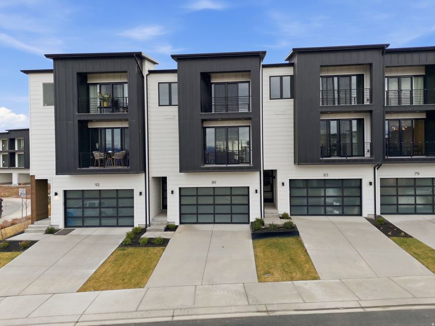 This is the model home opened to the public 11:00 am- 6:00 pm and Saturday from 10:00 am to 5:00 pm.** Experience elevated living in this stunning three-story luxury townhome located on the TalonsCove Golf Course and just moments from Utah Lake. Nestled in a prestigious resort-style community, this home offers the perfect blend of luxury, recreation, and scenic beauty.  The first floor features a versatile space ideal for a home office, guest room, flex area, or bedroom for those wanting to avoid stairs, along with a convenient half bathroom. The second floor showcases a bright open-concept layout with a spacious kitchen, dining, and living area. Floor-to-ceiling windows on both ends fill the space with natural light, creating an inviting and airy environment perfect for entertaining or relaxing.  This exceptional HOA community offers incredible amenities including a year-round natural heated mineral pool fed by local hot springs, a second outdoor swimming pool, two clubhouses with workout facilities and event space, and a private boat dock marina on Utah Lake. Residents also enjoy a large pavilion for hosting gatherings, multiple parks and playgrounds, and miles of connected walking and nature trails throughout the community.  The home itself is filled with premium and thoughtful upgrades including semi-custom soft-close cabinetry, 3 cm quartz kitchen countertops, a vent above the microwave, and high-end window and sliding glass door packages that enhance the home's modern design. The staircase is wider than standard homes and features a large statement window above the stairs that fills the space with light and adds to the luxurious feel.  Additional upgrades include 8-foot doors throughout, custom lighting, extra can lighting with ceiling fan wiring, soundproof walling in the toilet area for added privacy, internet access points installed in the walls, and plumbing for a water softener. The tankless water heater provides efficiency and convenience.  The garage is finished with durable epoxy flooring, an aluminum and glass garage door, added lighting, and a security camera for peace of mind.  Enjoy luxury living just steps from TalonsCove Golf Course and minutes from the water, where resort-style amenities, scenic surroundings, and modern design come together to create an exceptional place to call home.