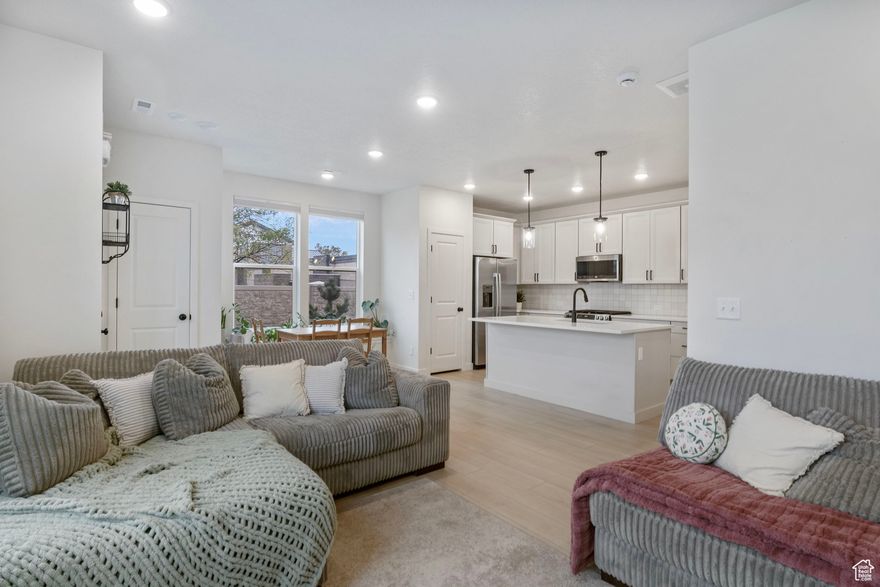 End-unit, turnkey, and priced $16K under the average price of builder's new inventory - a standout opportunity for buyers and investors seeking instant equity.  3br/2ba rear-load townhome fronting a rare, expansive green space inside a gated, pet-friendly community. Sun-filled interiors showcase a dining area with a picture-window seat and side-street views. The owner's retreat features a walk-in closet, double-sink vanity, and a spa-style enlarged shower.  Energy Star construction with blown-in insulation provides quiet, efficient comfort, and the HOA covers landscaping and snow removal for a true lock-and-leave lifestyle. A rear-load two-car garage offers convenient parking and extra storage while preserving clean curb appeal at the front.  The home includes $5,000 in custom blinds already installed, and all furnishings and appliances are negotiable, making this an ideal turnkey opportunity. Sellers are motivated and ready to make a deal-don't miss the chance to own this stylish, functional, move-in-ready home in an excellent location just five minutes from Walmart, Centennial Park, shopping, and restaurants.  Easy to show-schedule your tour today!