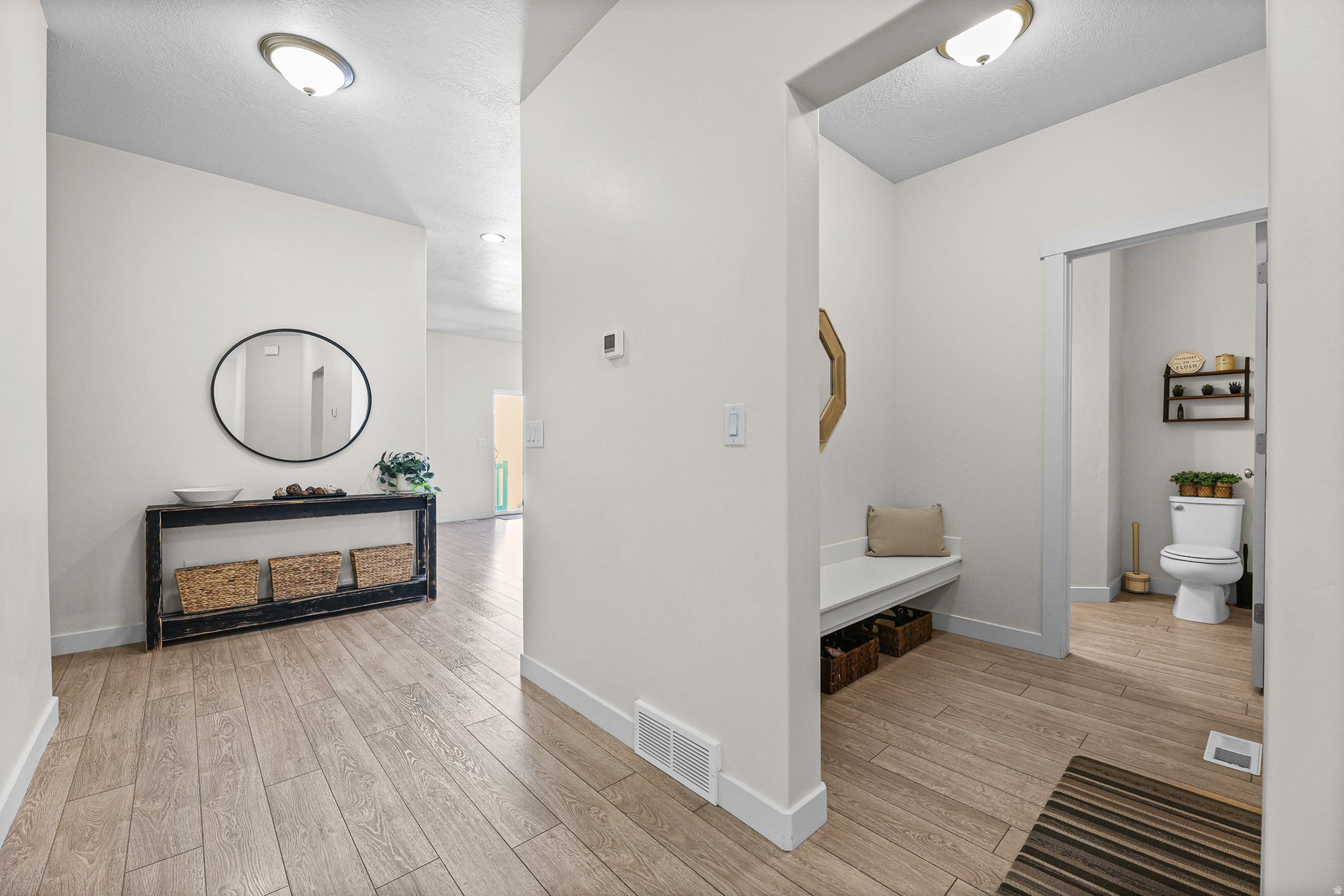 Entryway featuring wood-finish flooring and neutral wall tones