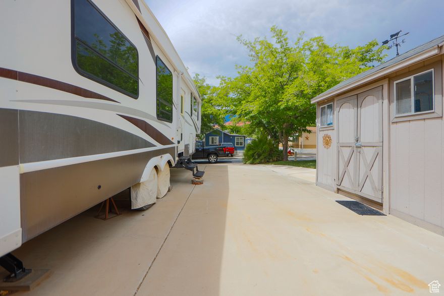 Affordable lot in Harrisburg Lakeside Estates with livable 5th wheel included. RV has slide-outs, washer/dryer hookups, a 5,000-watt generator, and storage shed. Lot has hookups for power, water, sewer, and gas. Quiet community with pool, near Quail Lake and Red Cliffs Recreation Area. Easy access to hiking, golf, and shopping. Great option for full-time living, recreation, or future build site.