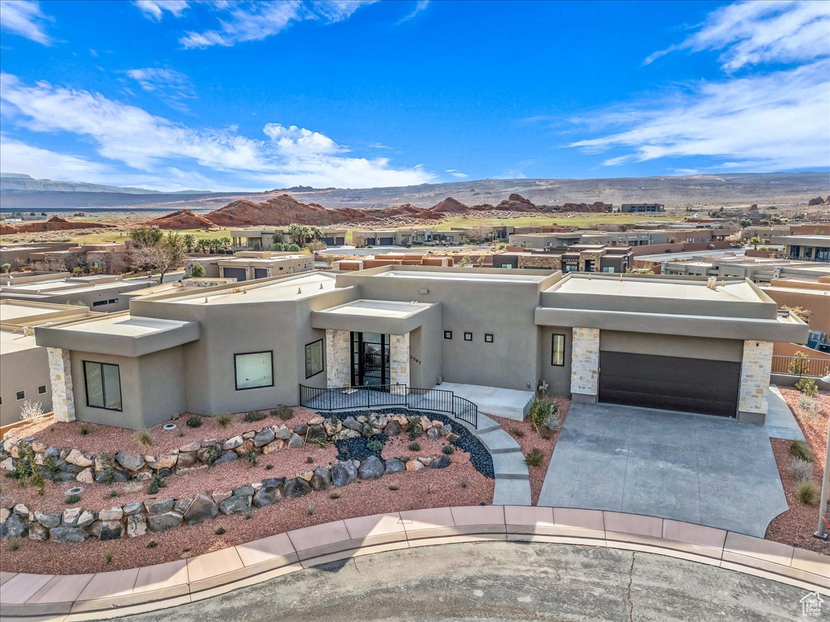 Nestled in Southern Utah's premier golf course community of Sand Hollow. This stunning 4 bedroom, 5 bathroom residence boasts breathtaking views and exudes luxury living! The expansive living room features floor to ceiling fireplace that seamlessly flows in the gourmet kitchen, complete with a spacious island, quartz countertops, high end appliances and abundance of storage. The walk out basement includes an additional family room, perfect for entertaining. Throughout the property, meticulous attention to detail is evident in the high end finishes, creating a sophisticated ambiance. The fully landscaped backyard provides a serene oasis with large deck for taking in the views. HOA amenities include access to community pools, pickleball courts as well as yard care.  Conveniently located just minutes from Sand Hollow State Park, sand dunes and multiple golf courses