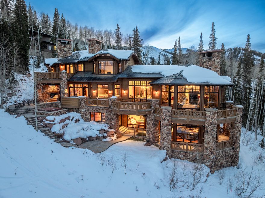 Set within the private, gated community of The Colony at White Pine Canyon, this remarkable ski-in/ski-out estate offers some of the largest and most unobstructed views of the mountains, basin and Park City area.  Positioned on 6.13 secluded acres surrounded by mature trees, the residence combines refined design with a warm, inviting atmosphere. The home features 8 bedrooms, 10 bathrooms, a private guest house, and a separate mother-in-law apartment, providing generous space for family and guests. The main living areas-anchored by the kitchen, dining spaces, and great room-are thoughtfully designed for gathering and connection, creating a comfortable flow throughout the home. Elegant mountain details include a formal dining area, wood-burning fireplaces, heated patio with fireplace, a dedicated ski room, theatre, private office, wine room, and a second living room with a game area. The main living room features a custom bar and opens seamlessly to the outdoor patio, creating the perfect setting for entertaining and relaxation.  With ski-in/ski-out access from the Twilight ski run of the Canyons Resort, this home is well equipped for adventure seekers.  The private ski room is thoughtfully designed and well organized, offering the perfect place to store and prepare gear for a day on the slopes.  With three laundry areas, garage space for five vehicles, a heated driveway, and expansive patios and circular drive - this home is convenient - balancing privacy, luxury, and access.  The Colony offers direct access to skiing, hiking, and biking, along with a stunning new homeowner clubhouse - a vibrant gathering place to connect, relax, and enjoy the spirit of this exclusive mountain community.