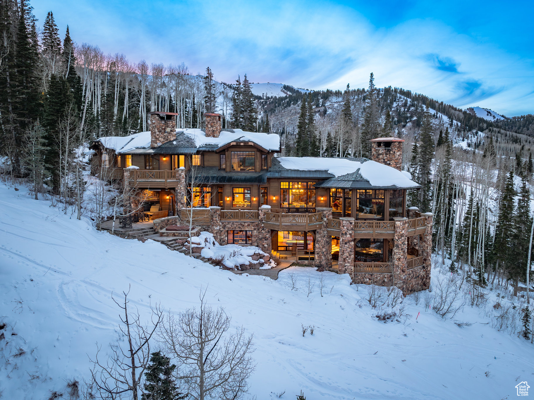 Designed for Park City ski mountain living, this residence features 8 bedrooms, 10 bathrooms, a private guest house, and a separate mother-in-law apartment, ensuring ample space for family and guests alike. Despite its grandeur, this mountain home feels quaint and intimate, as the kitchen, multiple dining areas, and living room are thoughtfully positioned in the main areas of the home. This layout offers both comfort and convenience, creating a cozy atmosphere within the expansive residence. With features such as wood-burning fireplaces, a well-appointed ski room, private office with French doors, ample storage, stainless appliances throughout, theatre, wine room, beautiful second living room with views, outdoor entertaining areas and patios, and direct ski-in/ski-out access. Set on 6.13 acres, this residence is surrounded by large, mature trees, giving a scenic backdrop and setting.