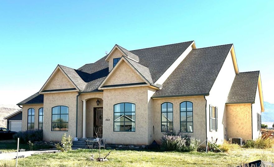 This luxurious French-country estate is built to inspire anyone who comes to visit, from its grand entrance, to its awe-inspiring architecture. This home is the epitome of grandeur and elegance. Located in Richfield in a quiet neighborhood, nestled in the backyard of Fishlake National Forest, with refreshing hot springs just minutes away, this home is the perfect place to escape the busyness of city life, hike, ride ATV's, bask in the breathtaking views everywhere you turn, and enjoy nature. As you enter this home, you are greeted with vaulted ceilings, pillars, custom moldings, and ornate chandeliers. Every room is spacious in this home. The grate room and primary suite open up to a large deck and fenced yard, where you can watch the clouds go by, catch breathtaking sunsets, or enjoy the splendor of the Milky Way Galaxy at night. Placed on 3 acres, you have room to breathe, play, and enjoy this piece of heaven where nature, luxury, and elegance come together.